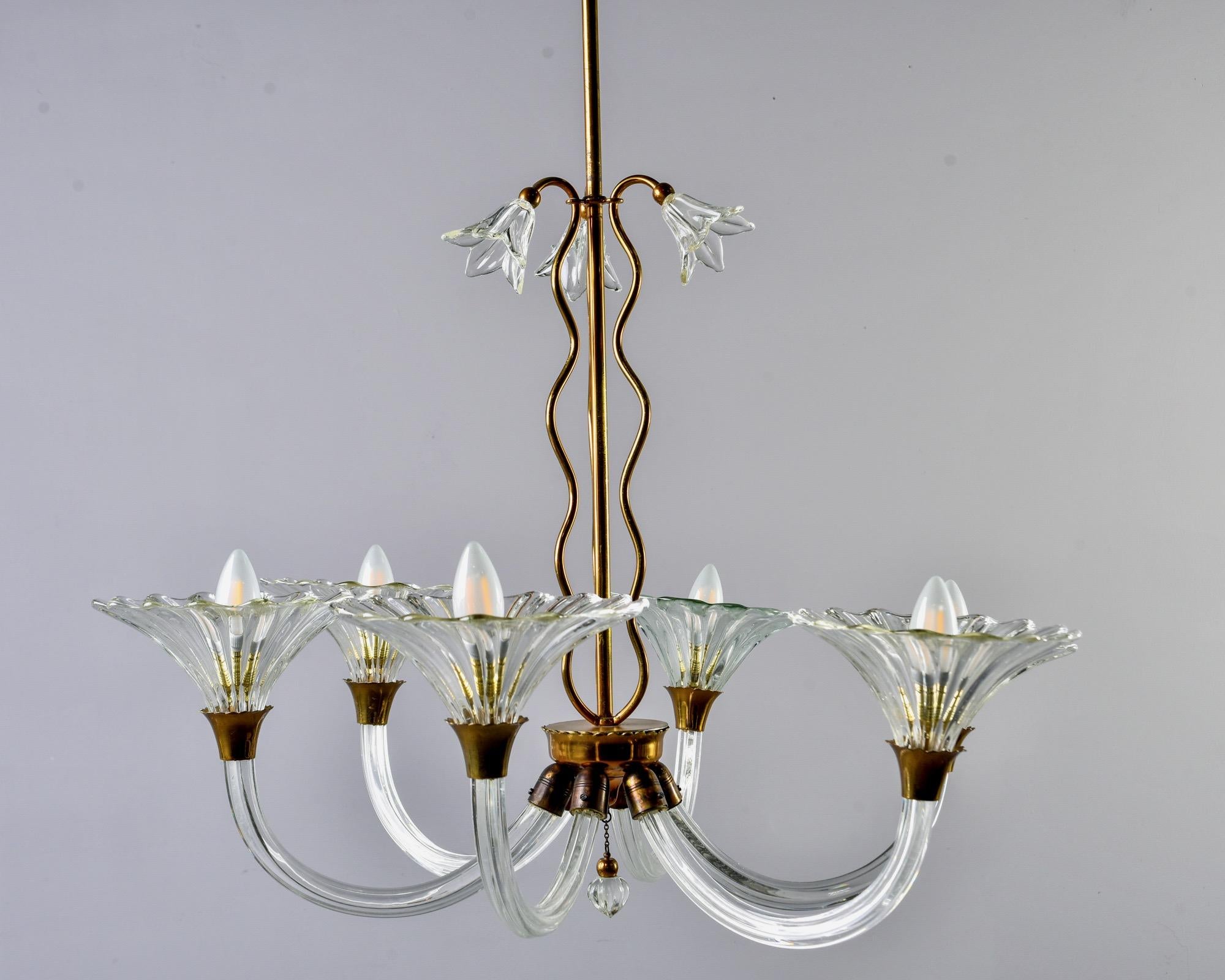 Six arm Murano glass chandelier attributed to Barovier and Toso circa 1930s. Original glass ceiling canopy, brass frame and clear mouth blown glass blooms at top. Six glass arms with mouth blown bobeches and standard sized sockets. New wiring for US