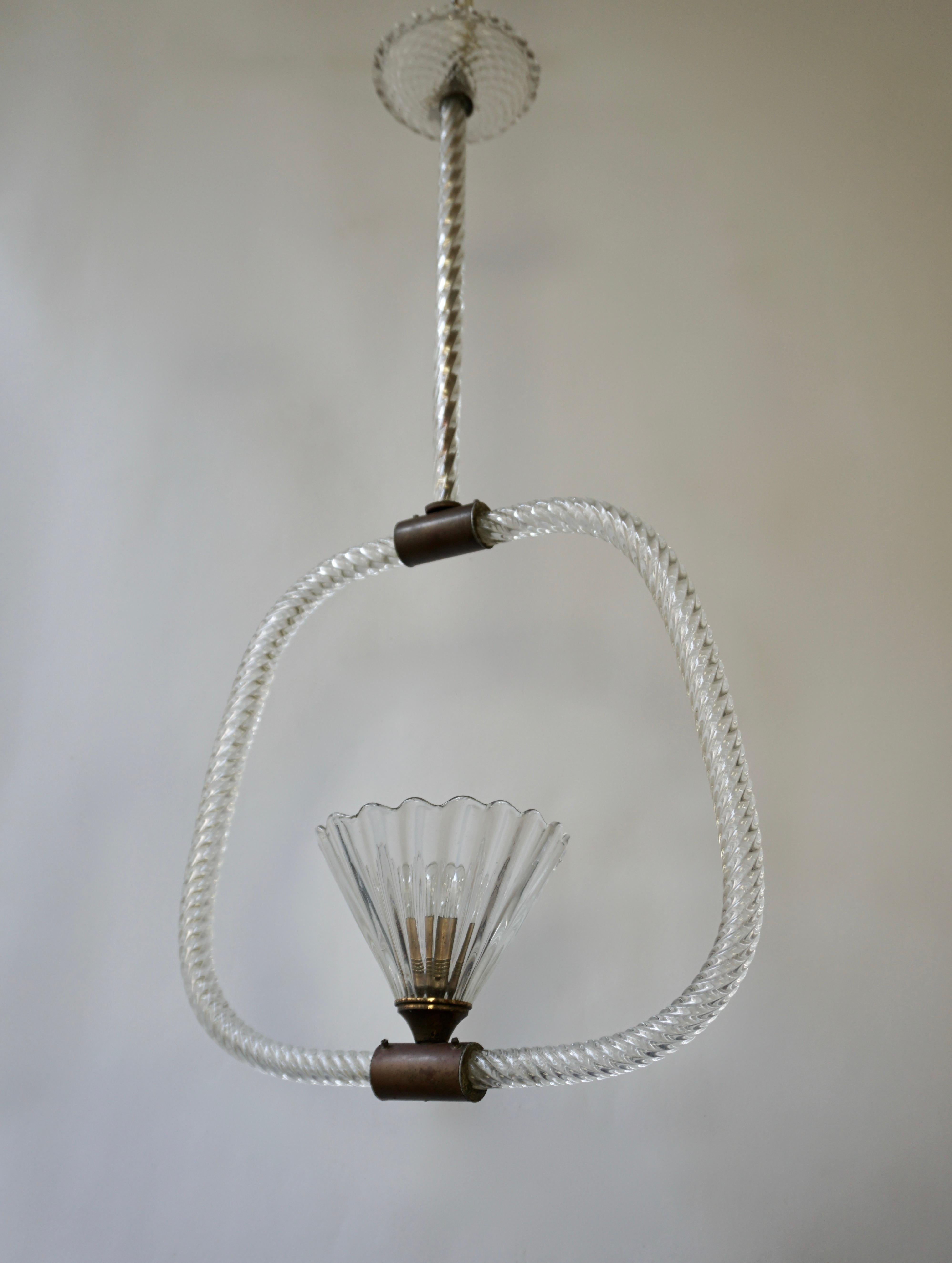 A glass semi-flush mounted pendant with a rope-twist detailed hoop-form body and stem with the central element and canopy having hatch-marked textures and scalloped edges. The brass fittings in their original aged finish. By the Italian maker