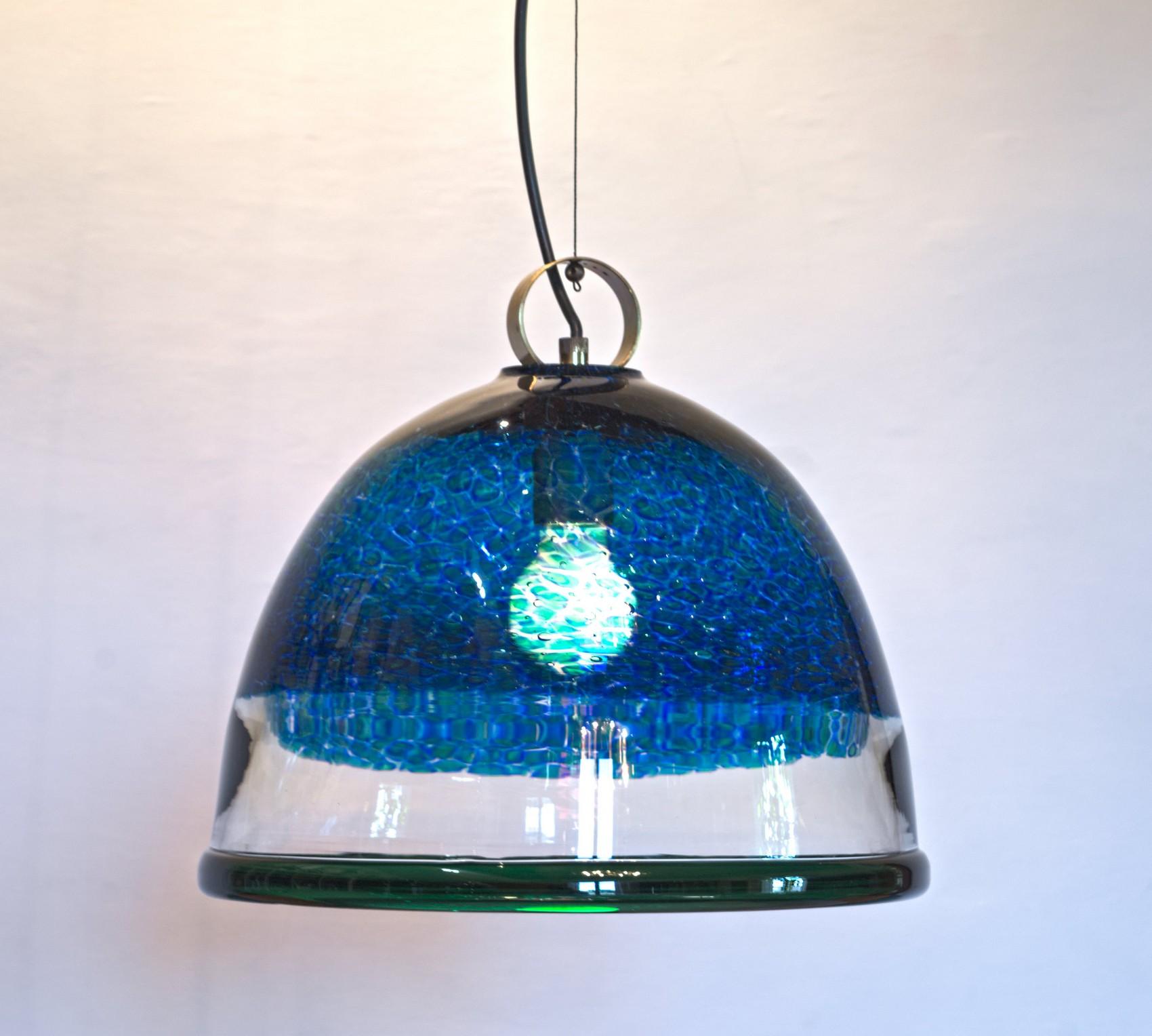 Pendant that was offered by Barovier and Toso in with blue or brown murrine. This is the vibrant bright one.
This fixture anticipates by a decade or two Vistosi Neverrino series and the murrine pendants.
Beautiful for an informal cozy seaside