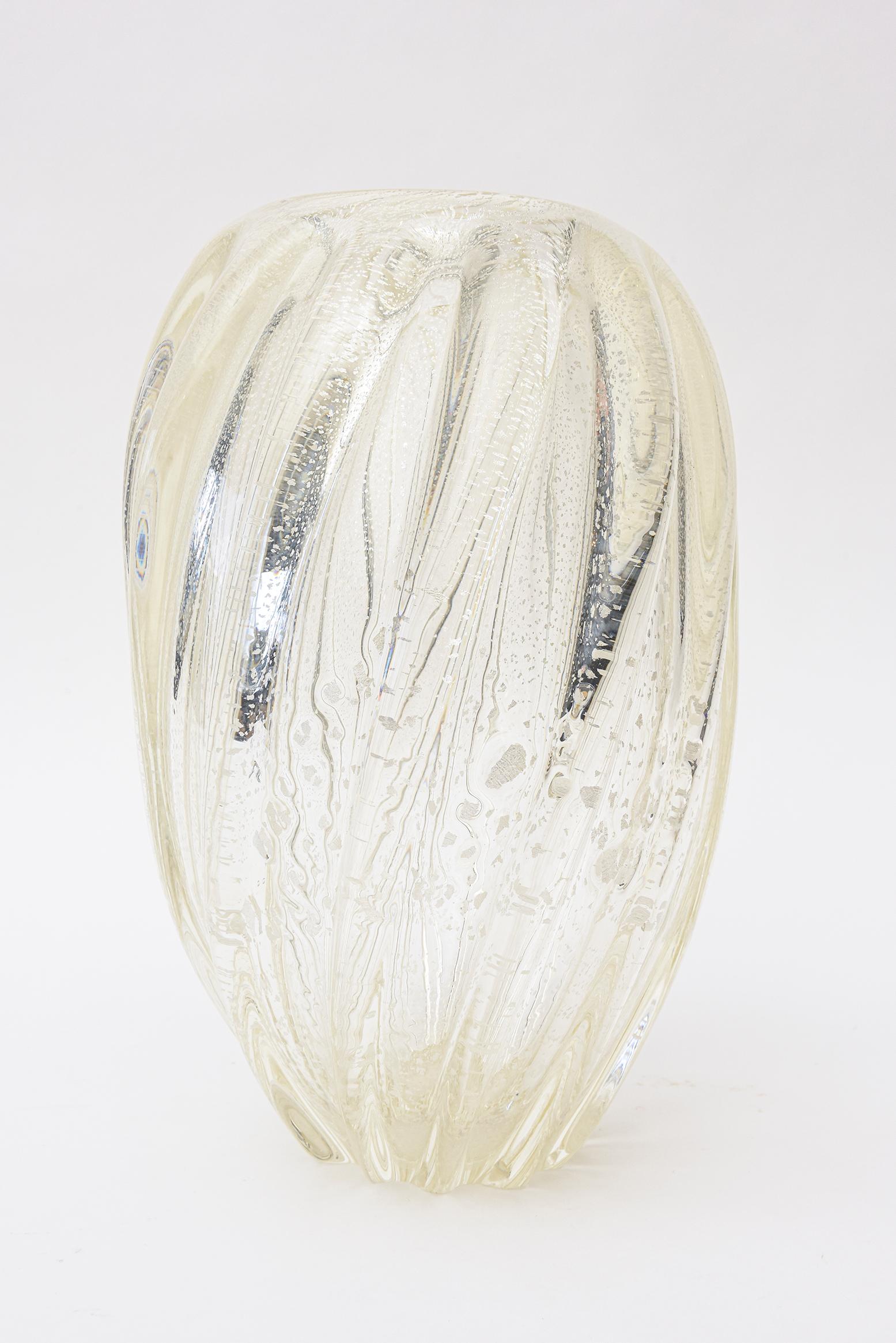 This stunning and large Italian Murano glass vase is by the masters of glass blowing: Barovier e Toso and is an early work of theirs from the late 1930s or early 1940s. It is ribbed swirled glass and has inclusions of white and silver foil