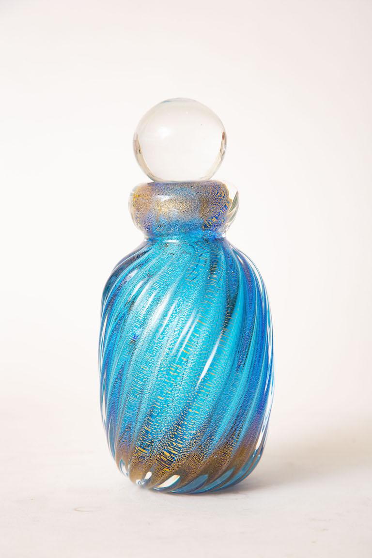 This gorgeous Italian Murano ribbed sapphire blue and gold aventurine glass bottle or perfume bottle is by Barovier e Toso and has the original sticker on the bottom. This is from the 50's or early 60's and is a beautiful color when all light hits
