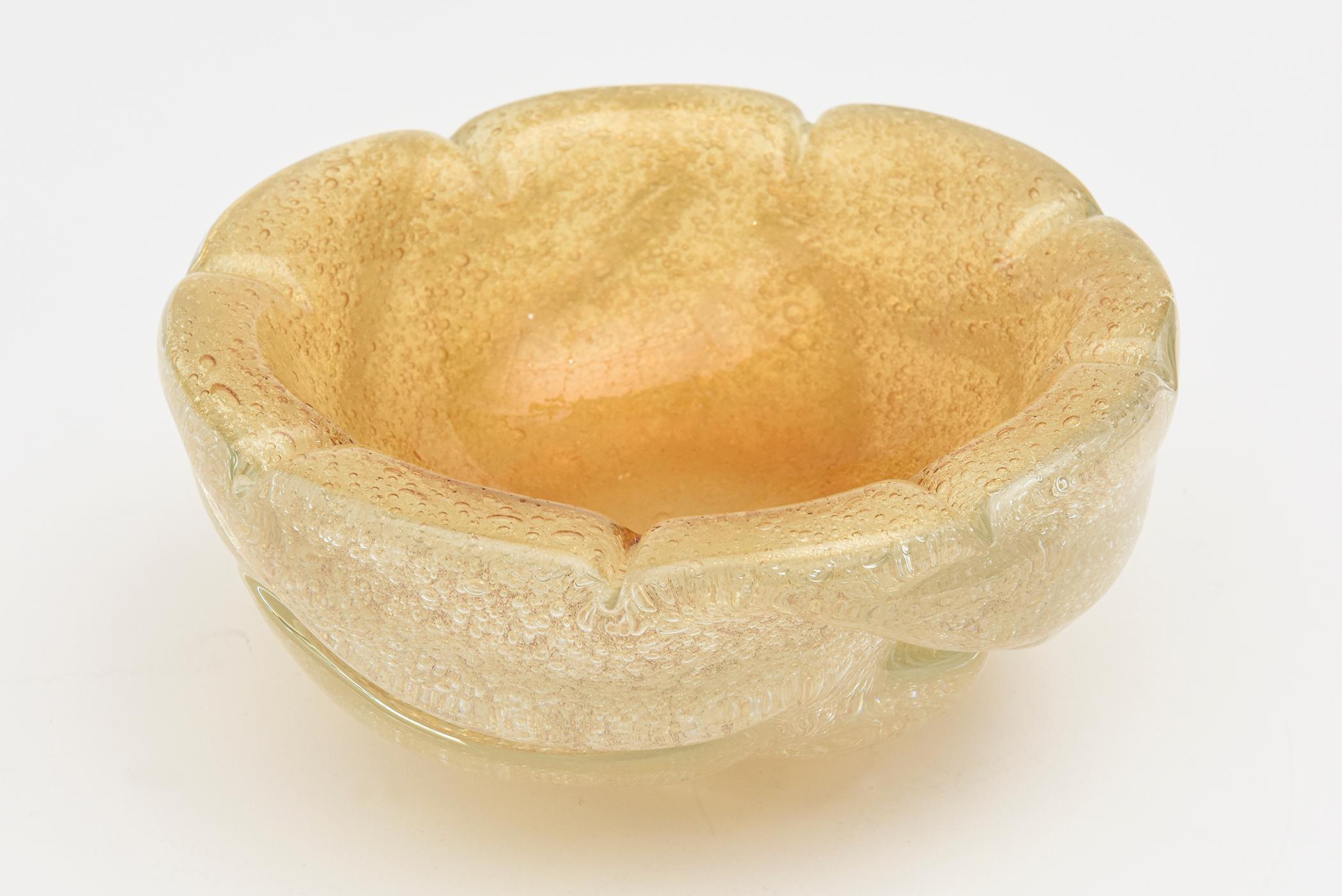 This thick chunky vintage Murano hand blown glass bowl is by the noted Barovier e Toso Dual of master glass blowers and artists. It is triple cased with tons of gold aventurine and bubbles of the technique called Pulegoso. It is clear with gold and