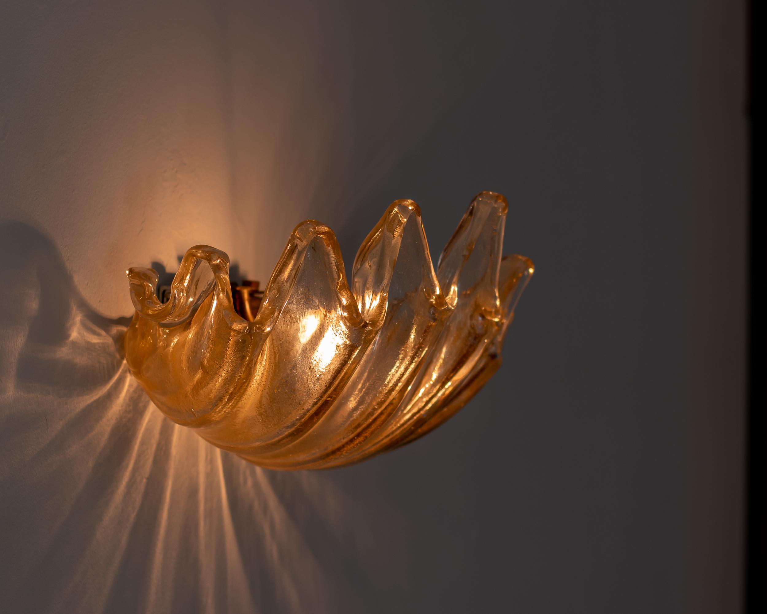 Ercole Barovier for Barovier & Toso rare pair of large clamshell sconces in heavy transparent iridescent glass featuring deep ribbing and pronounced lobes, Italy, circa 1940.   
These exquisite hand-blown crystal wall lights are elegant and