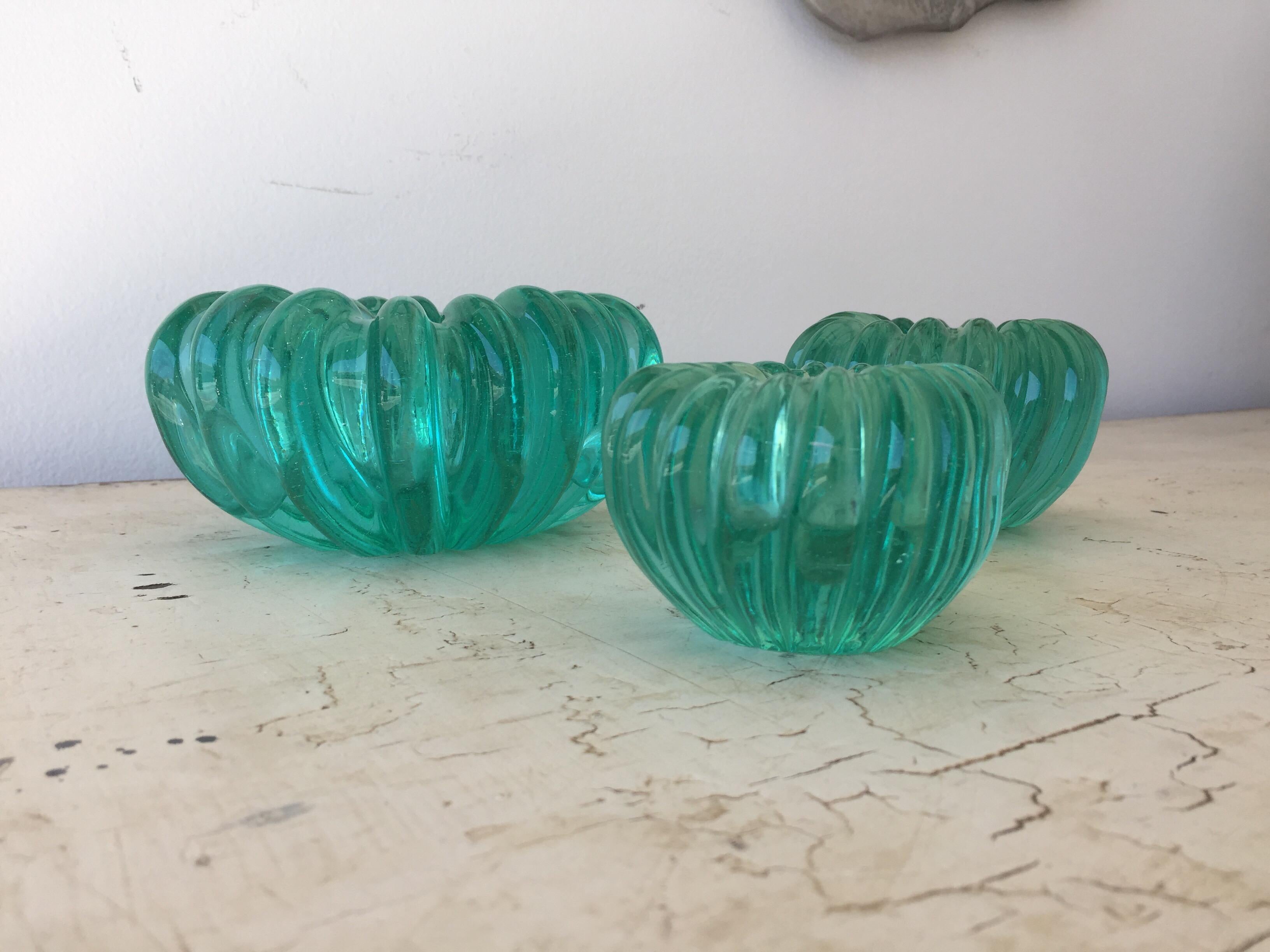 Three beautiful Murano bowls in descending sizes, rich jewel-tone green, all hand blown. 

Dimensions of bowls: Large = 6.5 W x 5.75 D x 3.25 H, medium = 4.75 W x 4.25 D x 3 H, small = 3.75 W x 3.25 D x 2.5 H.