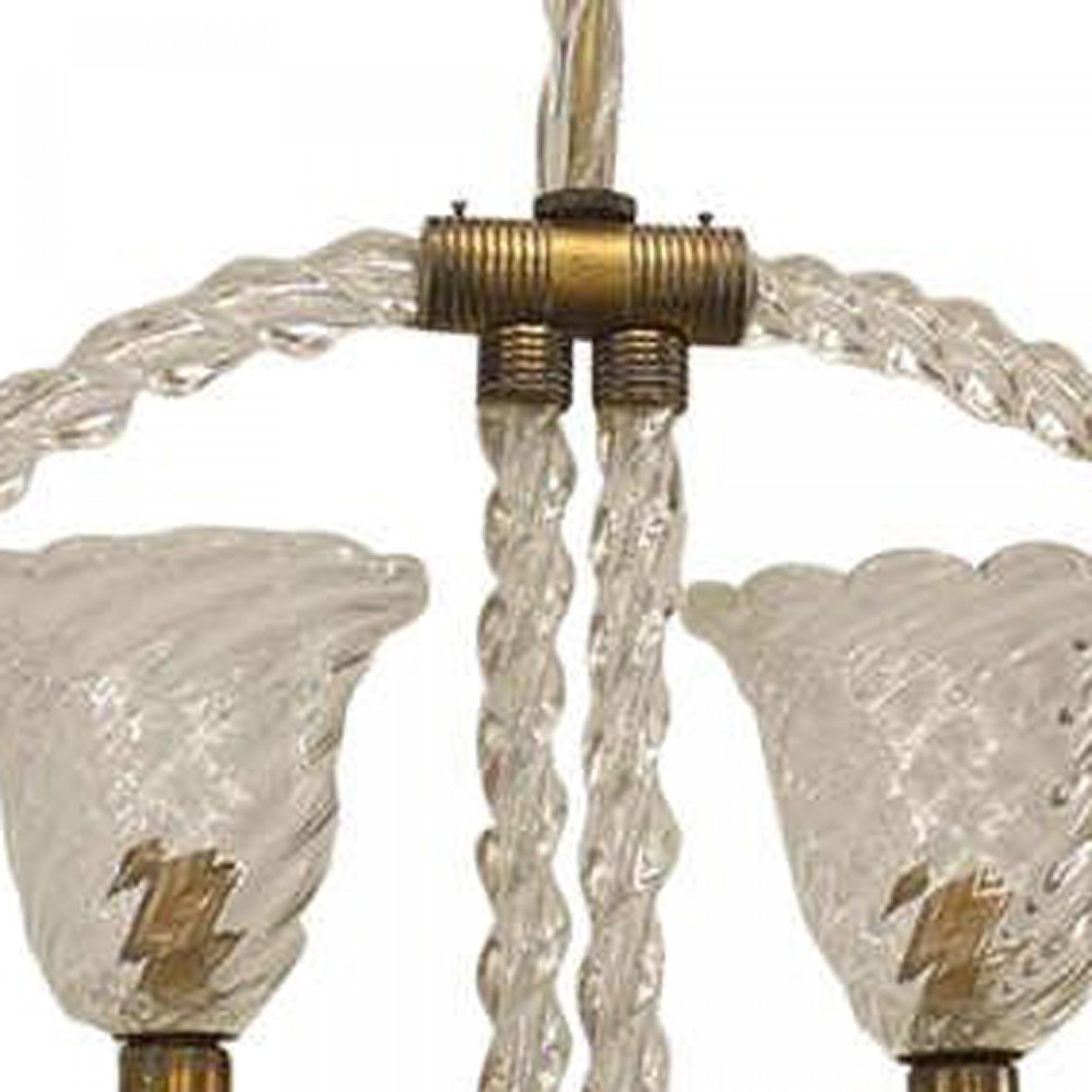French (1940's) chandelier featuring a suspended hoop composed of clear glass and brass trim that features two curved arms supporting swirl-design glass shades (BAROVIER ET TOSO)
