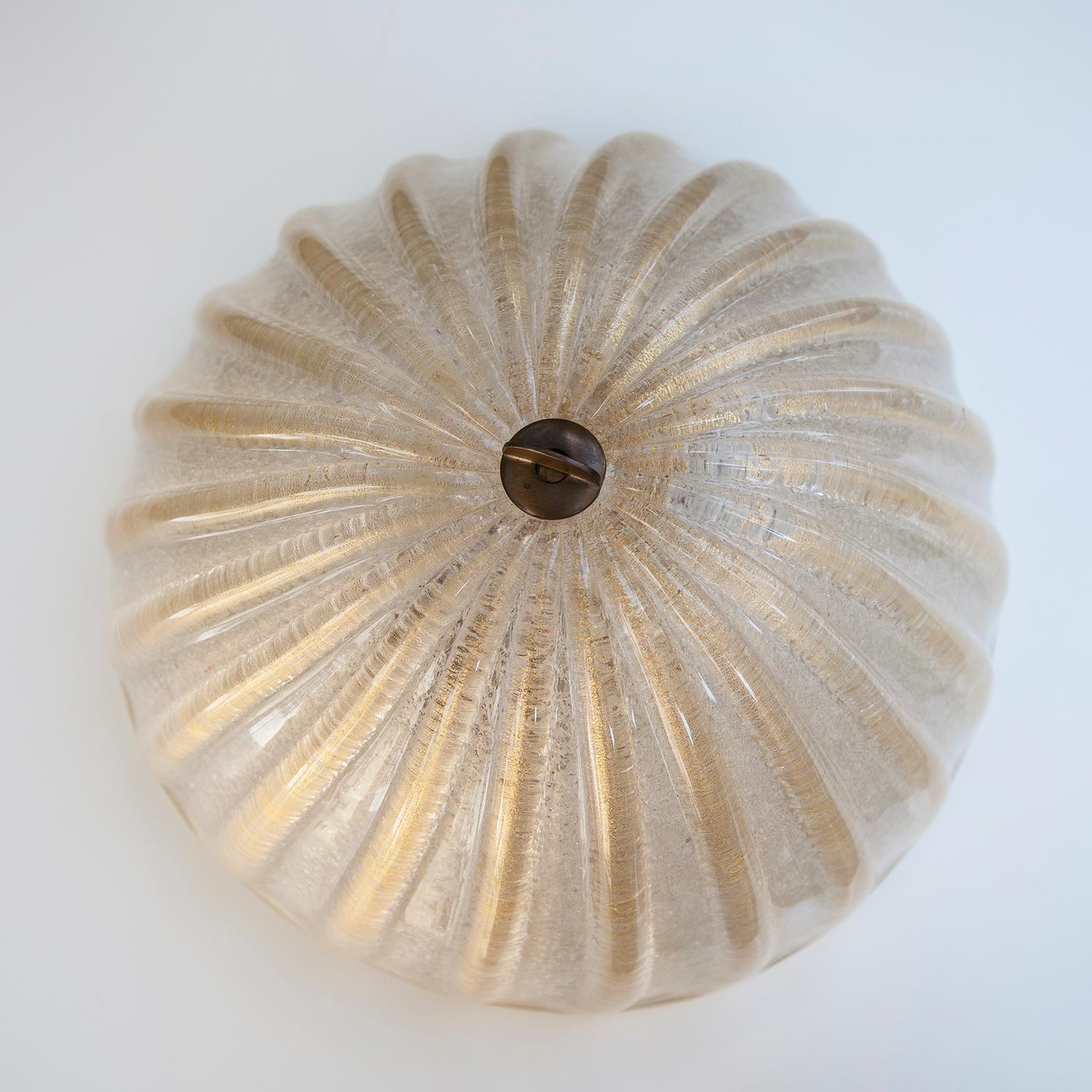 Vintage Barovier and Toso Murano art glass flush mount, with golden powder round glass shade on a brass base. Especially when lit it gives a warm glow.
 
   