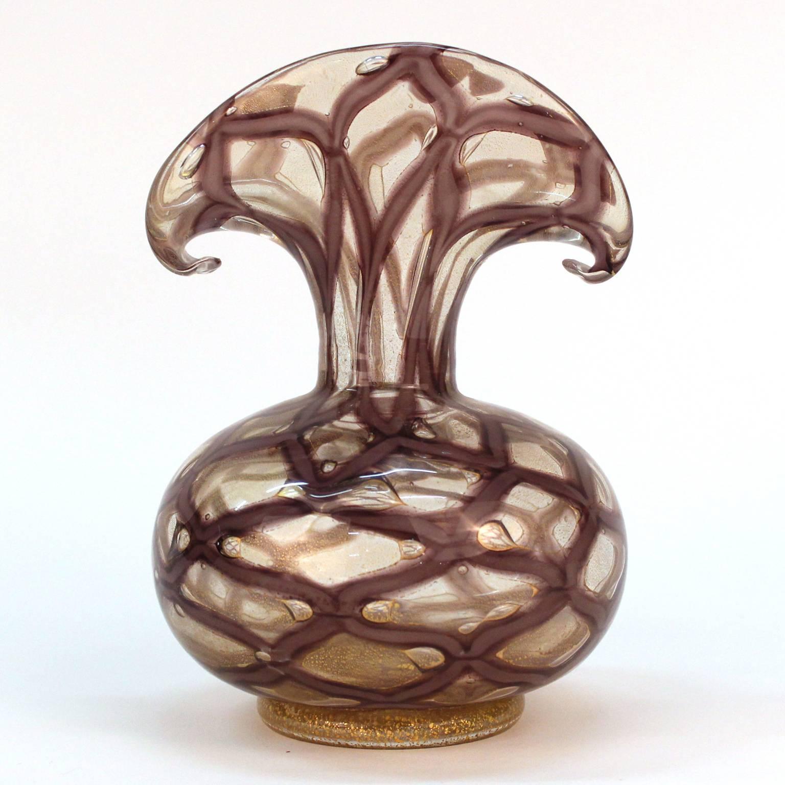 A Graffito technique vase made by Barovier in purple Murano glass with 24-karat gold flakes. Very good condition; unsigned.