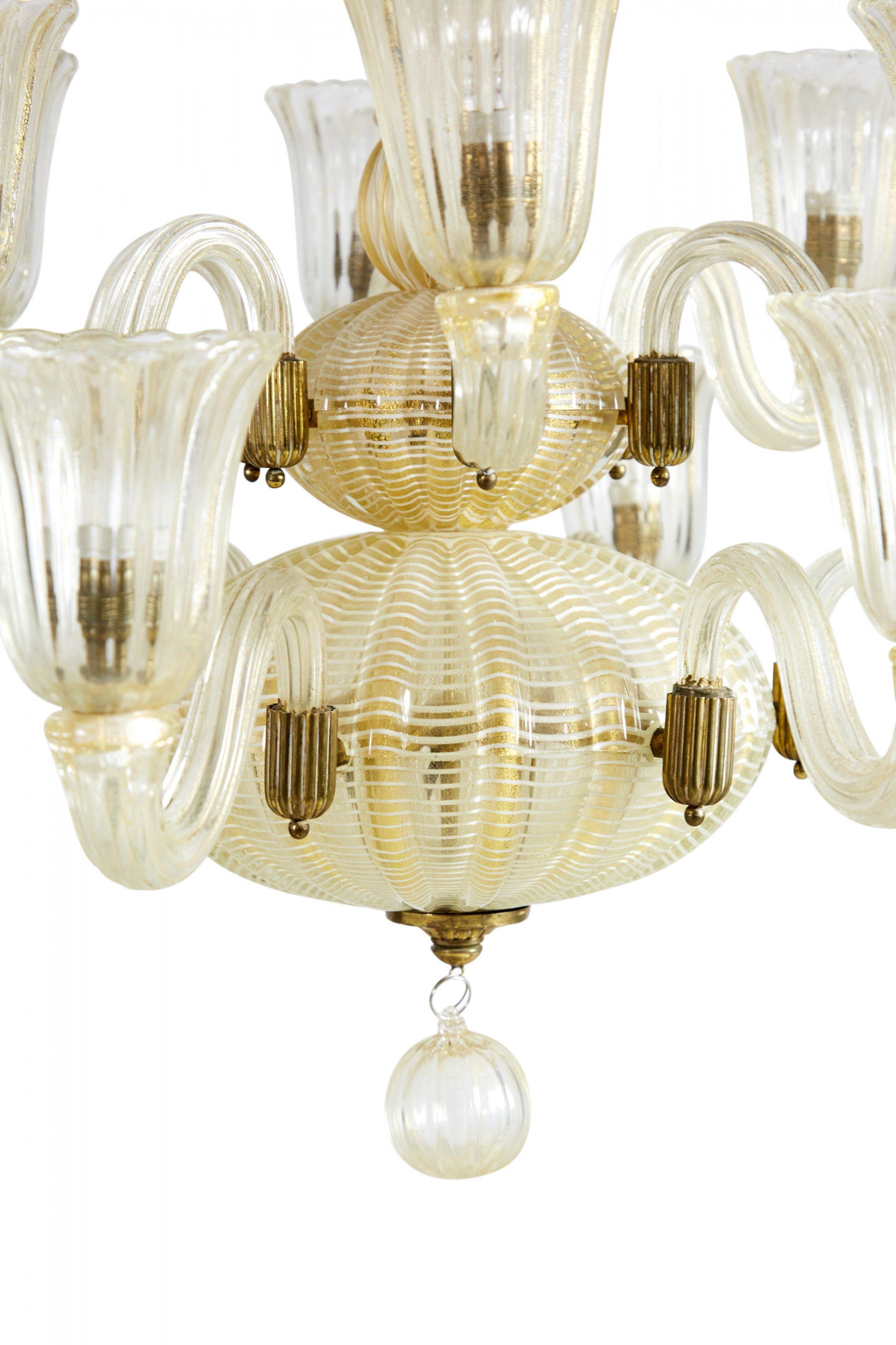 Italian Art Deco (1930s) gold-infused glass chandelier with 12 arms on two tieres, mounted to a central canopie with fluted shades. (BAROVIER).
    