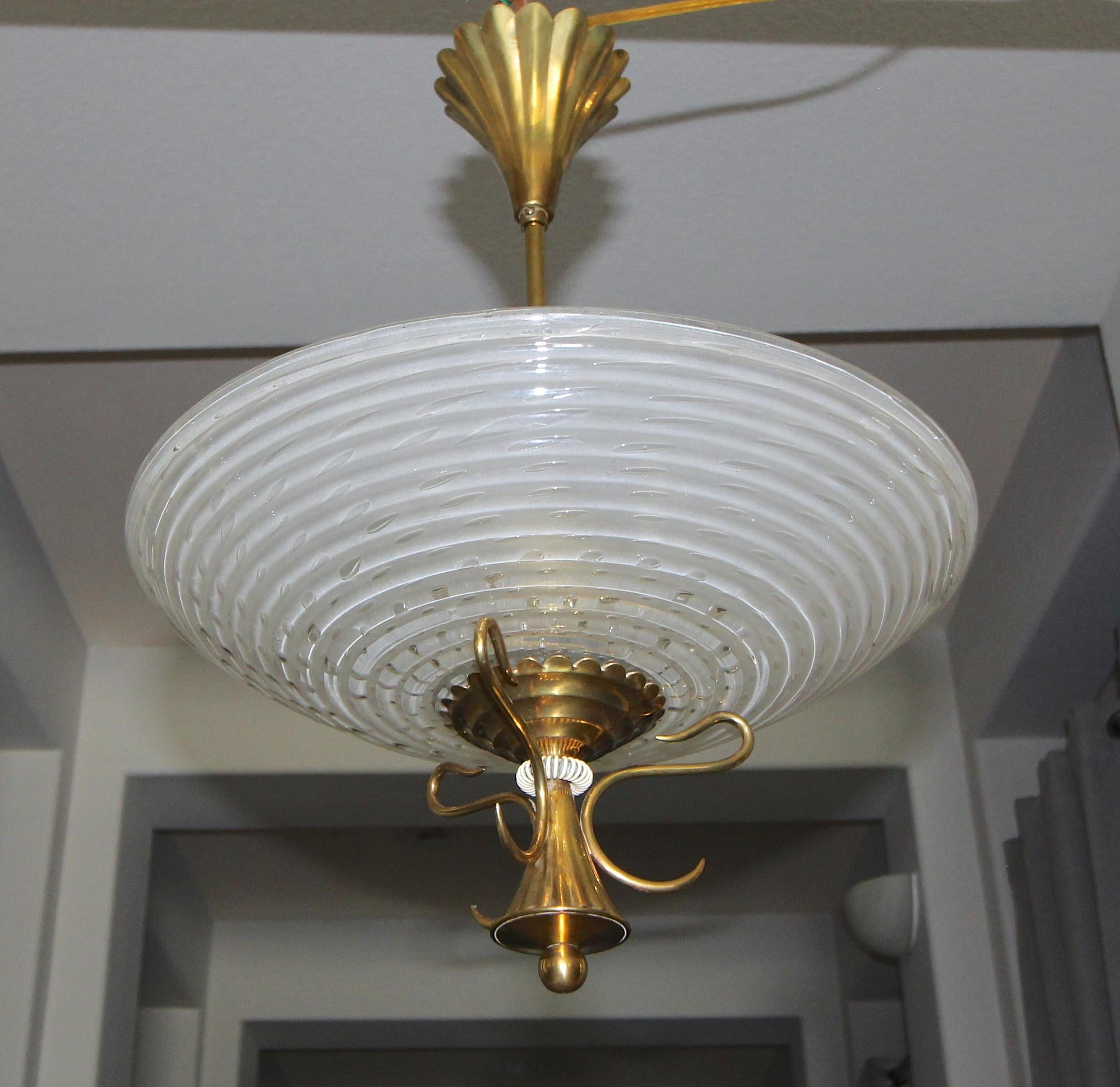Italian Barovier pendant light with bowl form Murano glass ribbed shade with control bubbles and acid etched back to diffuse light. Glass is suspended on distinctive moderne brass frame and fittings. Fixture uses 2 candelabra base bulbs, newly