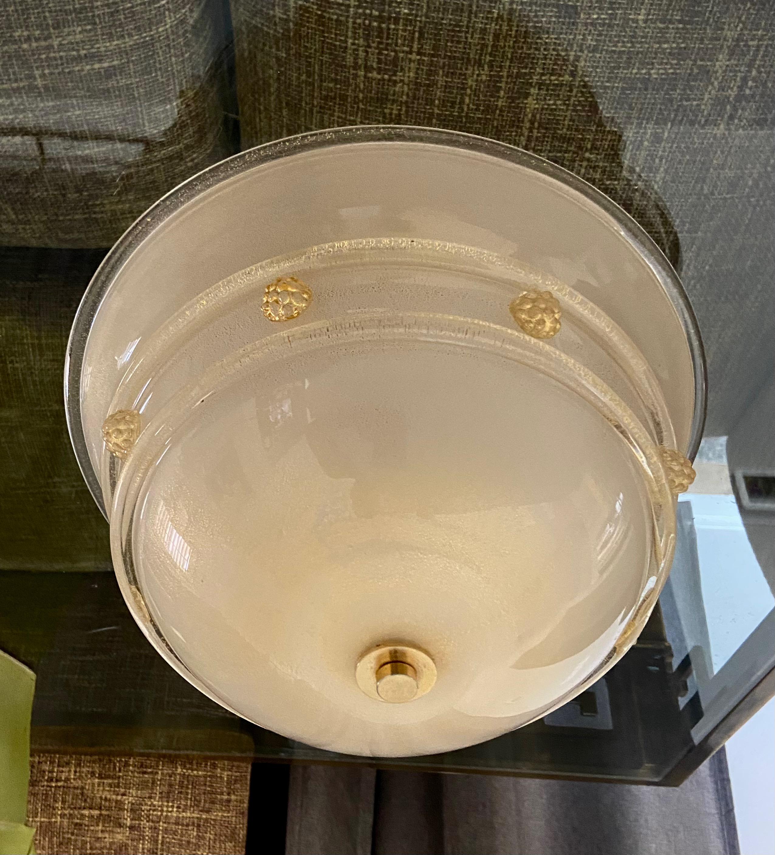 Flush mount ceiling light by Barovier & Toso. Thick opaque glass covered by clear glass with fine scattering of gold flecks. Glass details and florets are in clear and gold. Metal mounting plate in white paint uses 3 candelabra base bulbs.