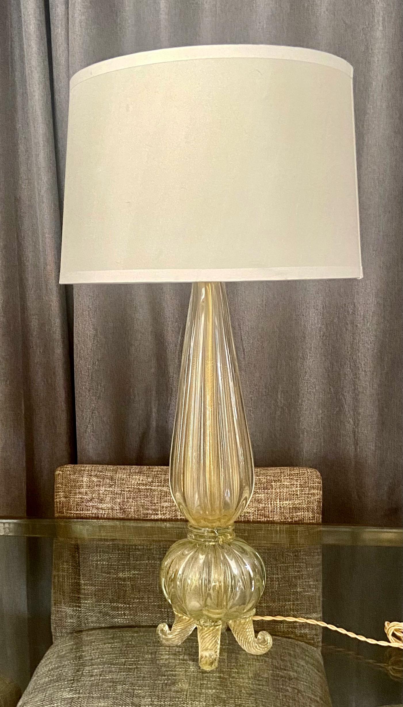 Handblown Murano Italian footed glass table lamp with lots of gold inclusions, by Barovier & Toso. Rewired with new full range socket and French style rayon covered cord. This stylist lamp goes perfect in most modern or traditional decor. Shade not