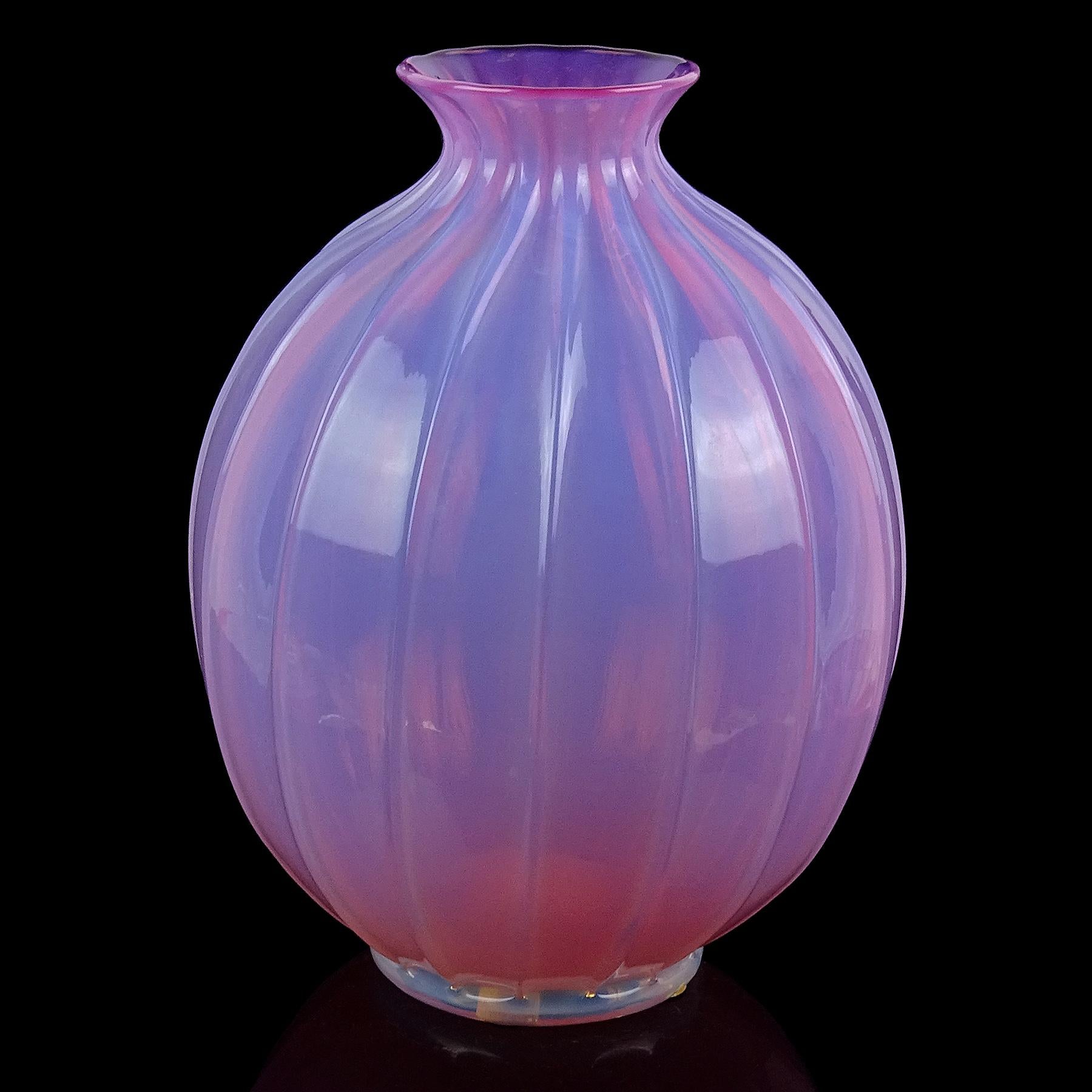 Beautiful and large, vintage Murano hand blown opalescent pink and white foot Italian art glass flower vase. It is attributed to the Barovier e Toso company. The surface of the vase has a paneled design all the way around, and has an applied opal