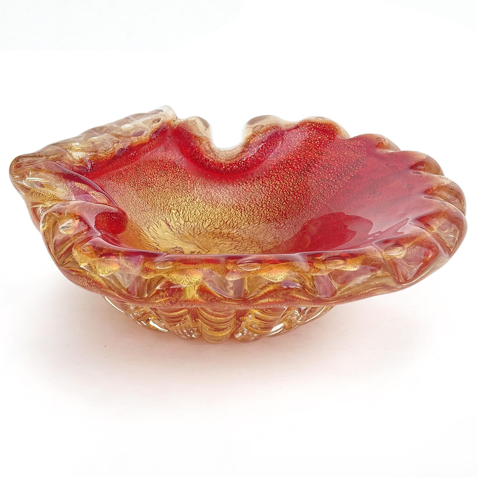 Beautiful vintage Murano hand blown red, controlled bubbles and gold flecks Italian art glass sculptural fan shape conch / seashell bowl. Documented to the Barovier e Toso company. The bowl has an early original Italian gallery label, which reads
