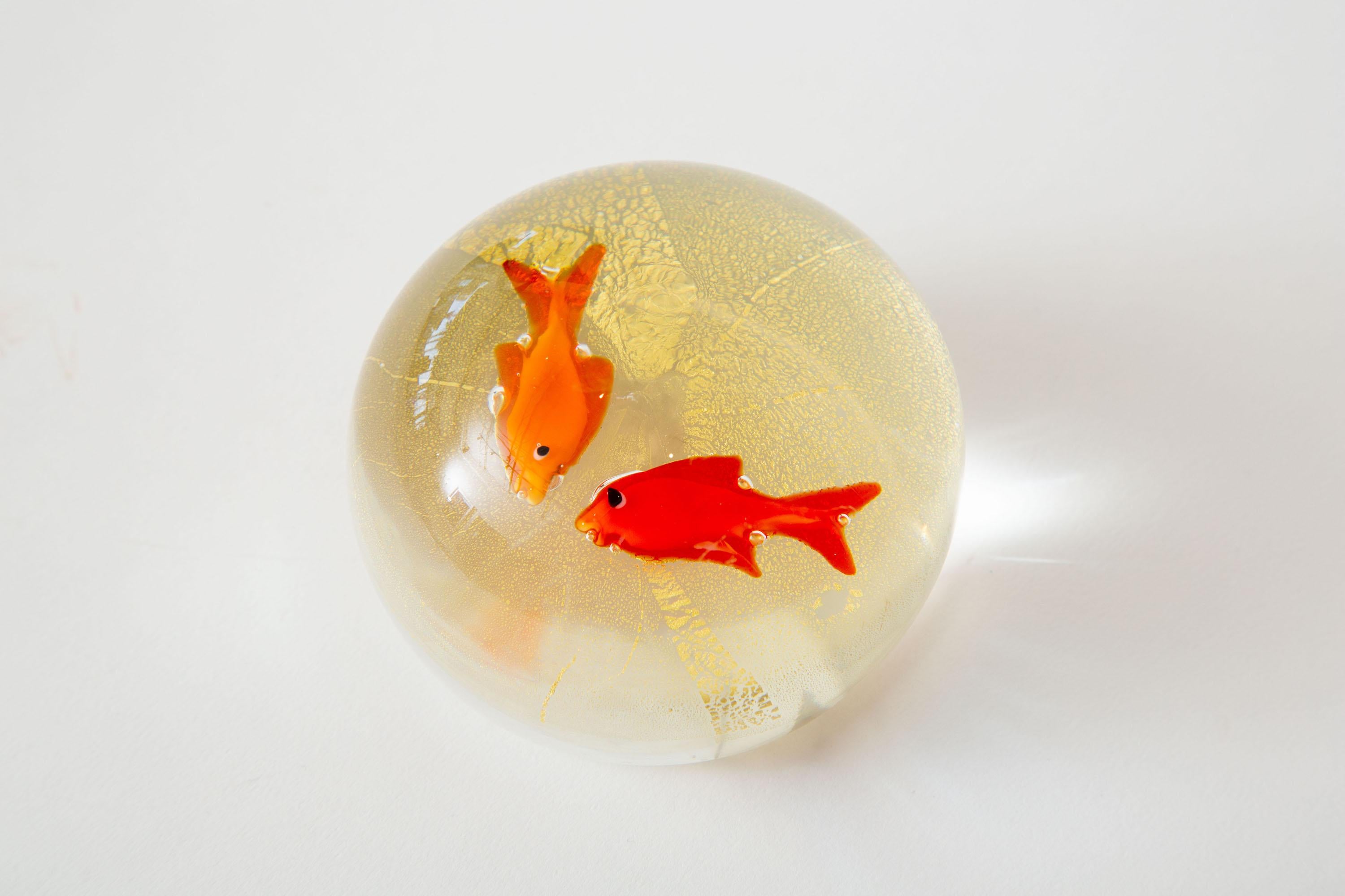 This happy and fun Italian Murano Barovier e Toso domed glass paperweight and or desk accessory has two fish as the forefront in red and orange floating in a bed of gold aventurine. It is vintage from the 1960s.