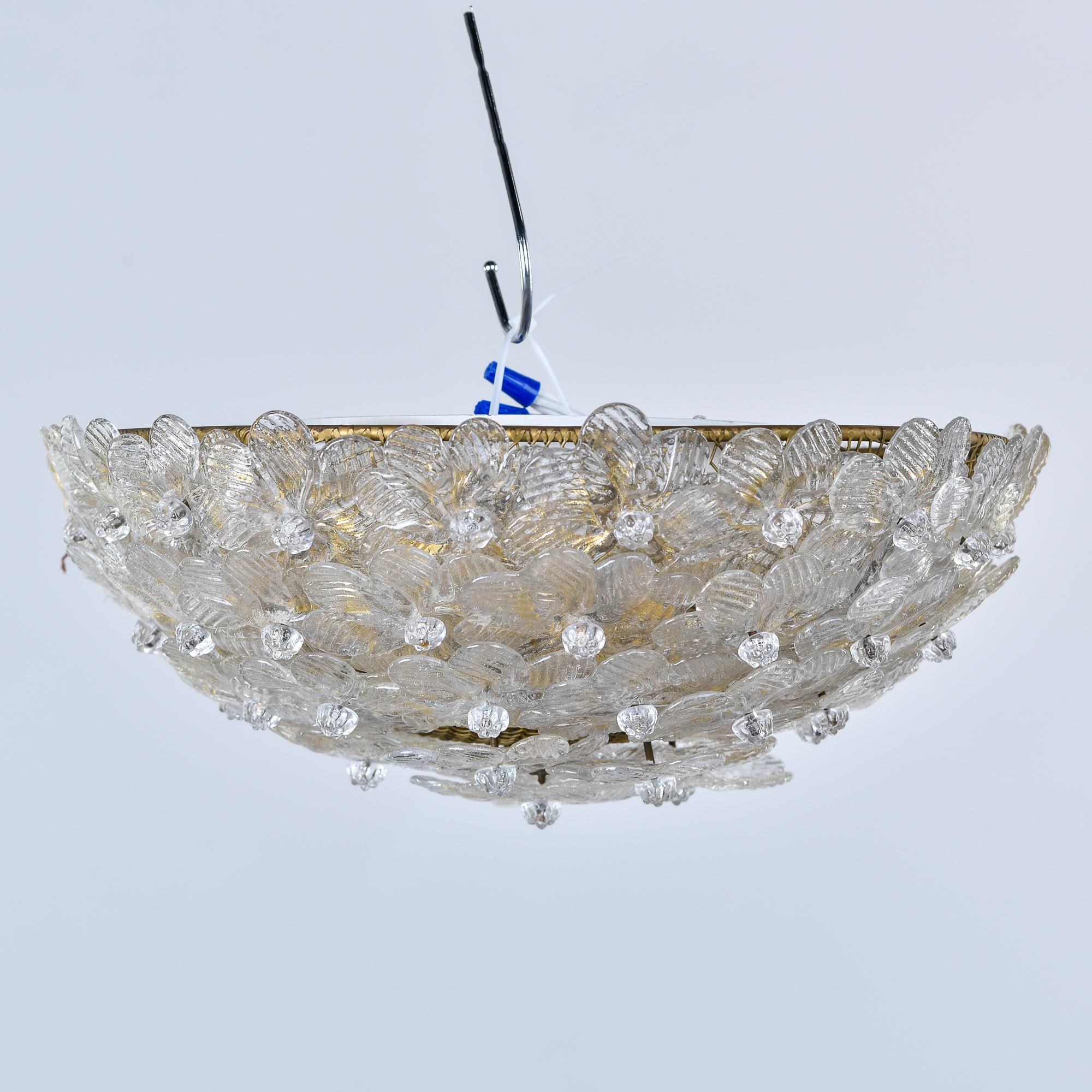 Found in Italy, this circa 1970s flush mount fixture is attributed to Barovier. Bowl-shaped fixture is covered in clear and gold Murano glass flowers and has three internal candelabra-sized sockets that have been rewired for US electrical standards.