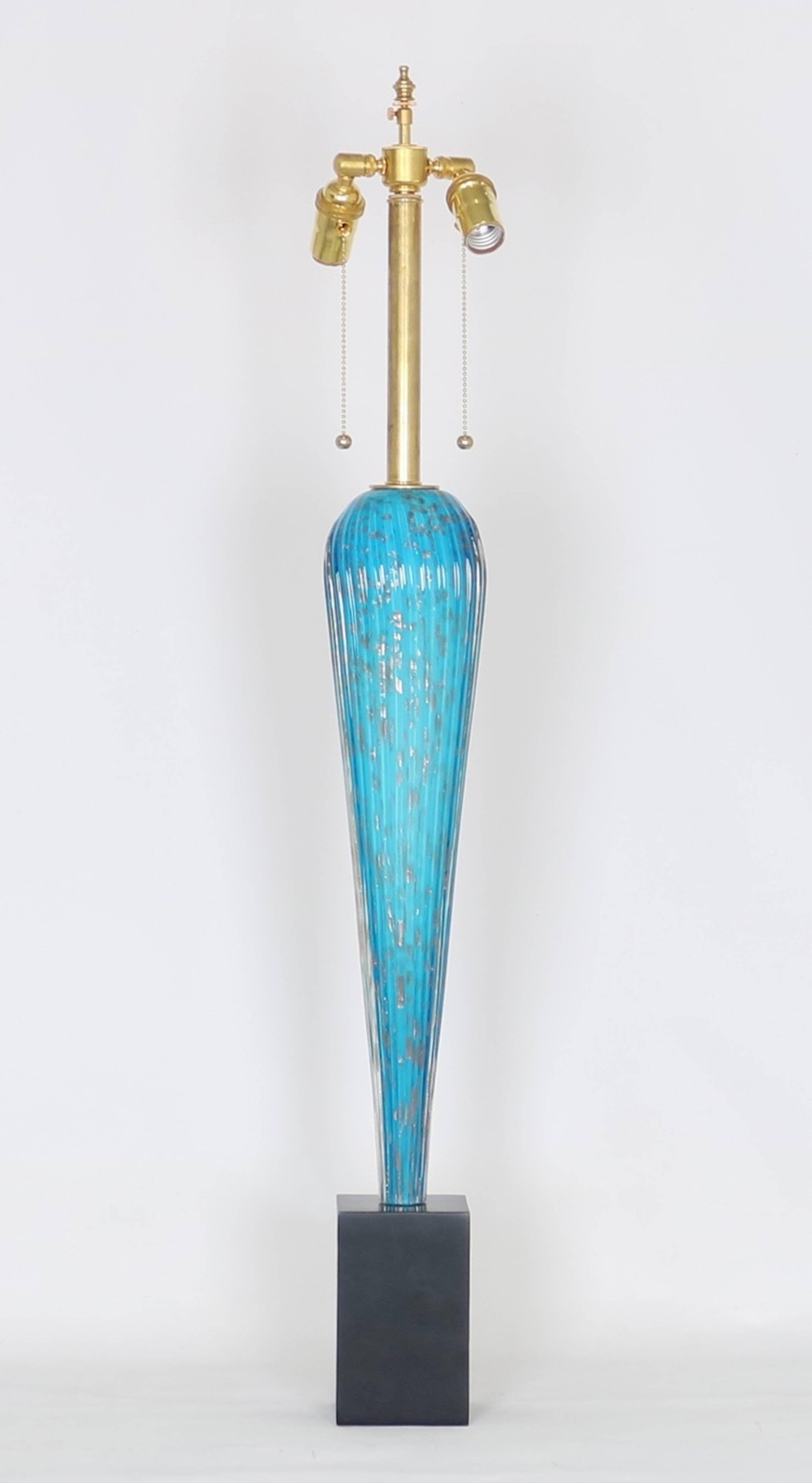 Barovier Murano glass table lamp on ebonized stand. Features a tapered ribbed glass body half in bright blue glass and the other half in white glass. Flecked with copper throughout . Fully restored with all new wiring and hardware including a double