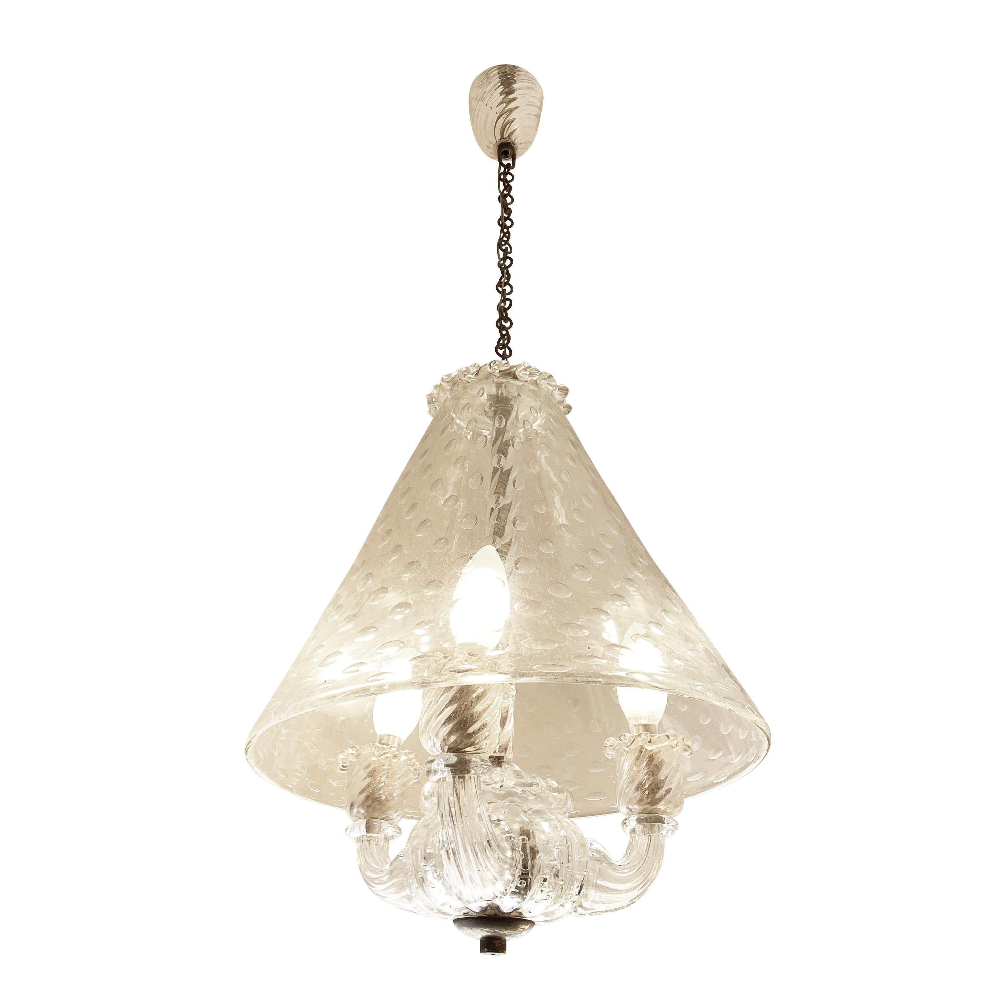1940’s Murano glass pendant by Barovier featuring a conical glass dome with infused bubbles. Below the dome are three glass arms each holding a candelabra bulb. Mounted on its original chain and terminating with a glass canopy. Height of chain can