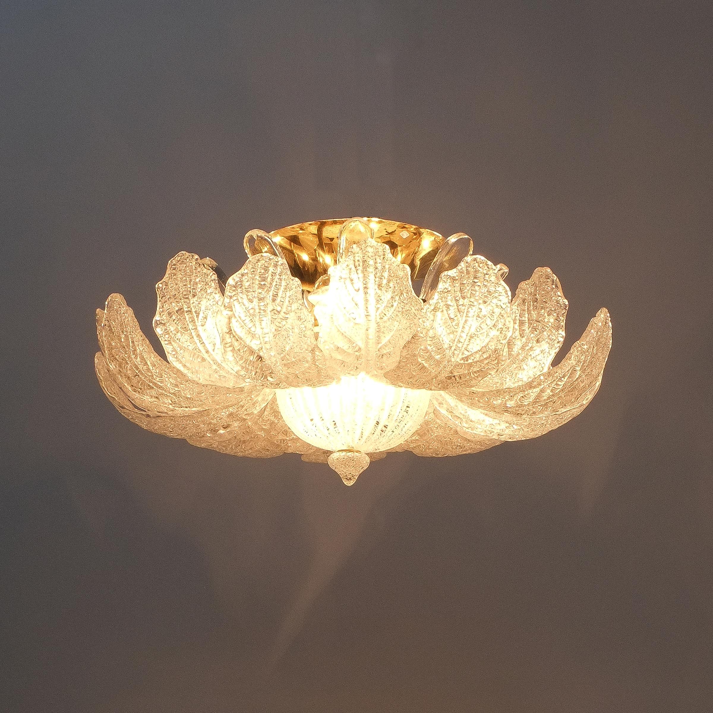 Labelled Barovier Toso flush mount in excellent condition, Italy circa 1965

Barovier Toso flush mount or chandelier from glass and brass. Wonderful handmade petal glass pieces circulating around brass hardware. The ceiling light is labelled and
