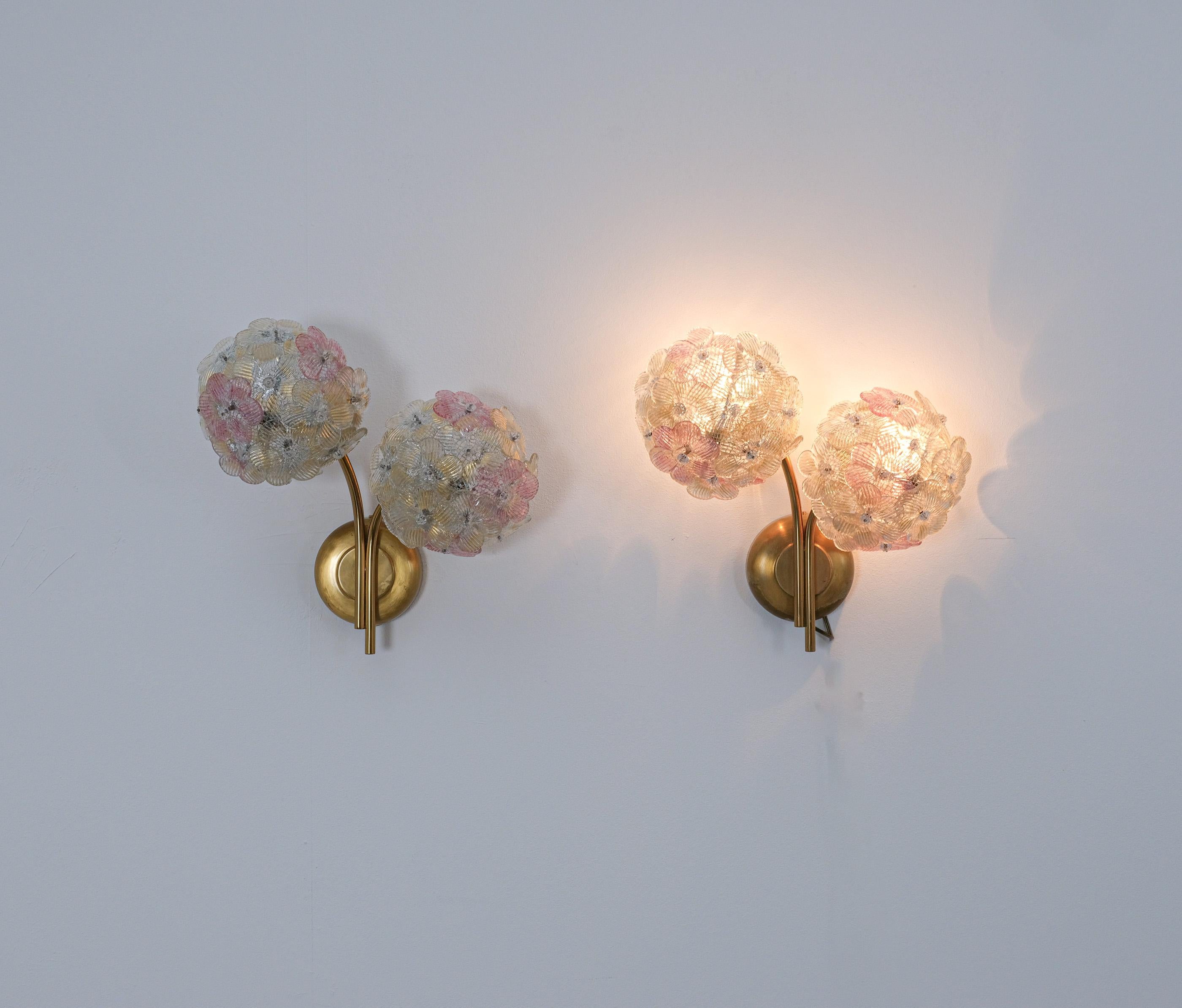 Barovier Toso set of three large sconces, Italy circa 1960, sold as a set.

Barovier & Toso sconces from glass and brass. Wonderful handmade petal rose, white and yellow colored glass flowers attached to a metal mesh dome. The hardware is from
