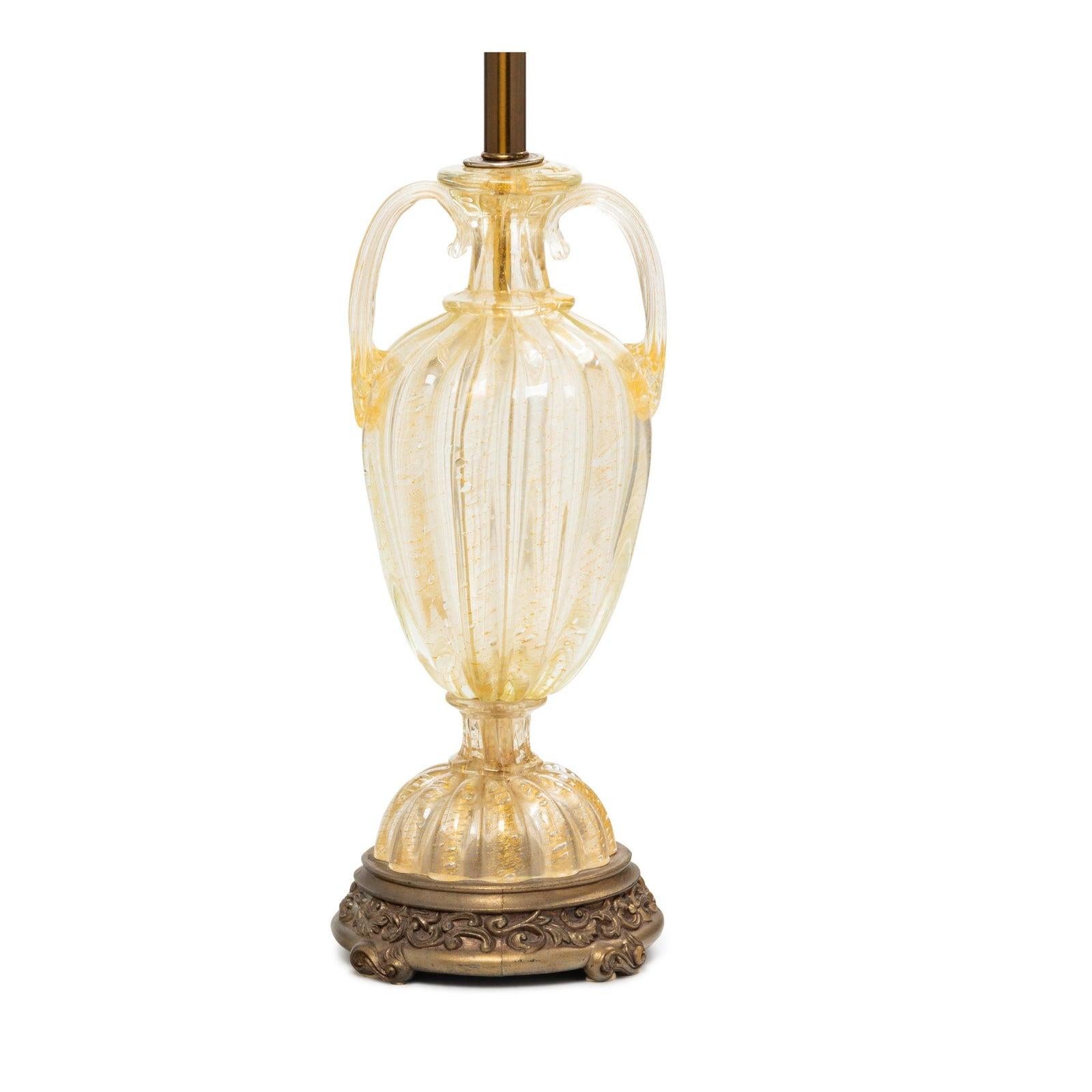 Barovier & Toso mid-20th century Murano Italian art glass table lamp, custom shade

This lovely lamp features gold inclusions in clear glass and includes an expensive hand smocked shade.