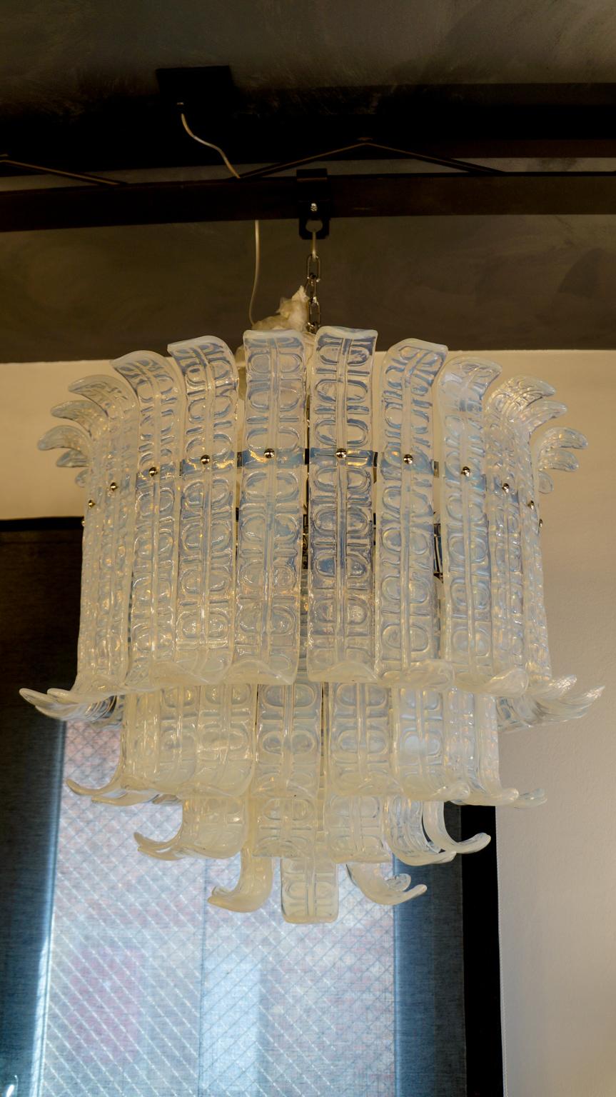 Designed in 1972 by Barovier & Toso, this chandelier contains 65 opaline-colored elements.
The chandelier can be reconditioned according to the country of destination. It has 10 lights that help illuminate the glass creating magnificent lighting