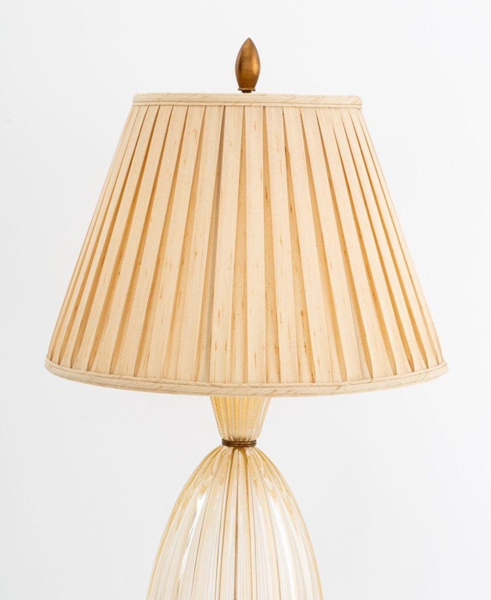 Barovier and Toso Murano Art Glass Table Lamp, the gold-flecked fluted vasiform base with brass mountings, with pleated linen shade. Overall: 38