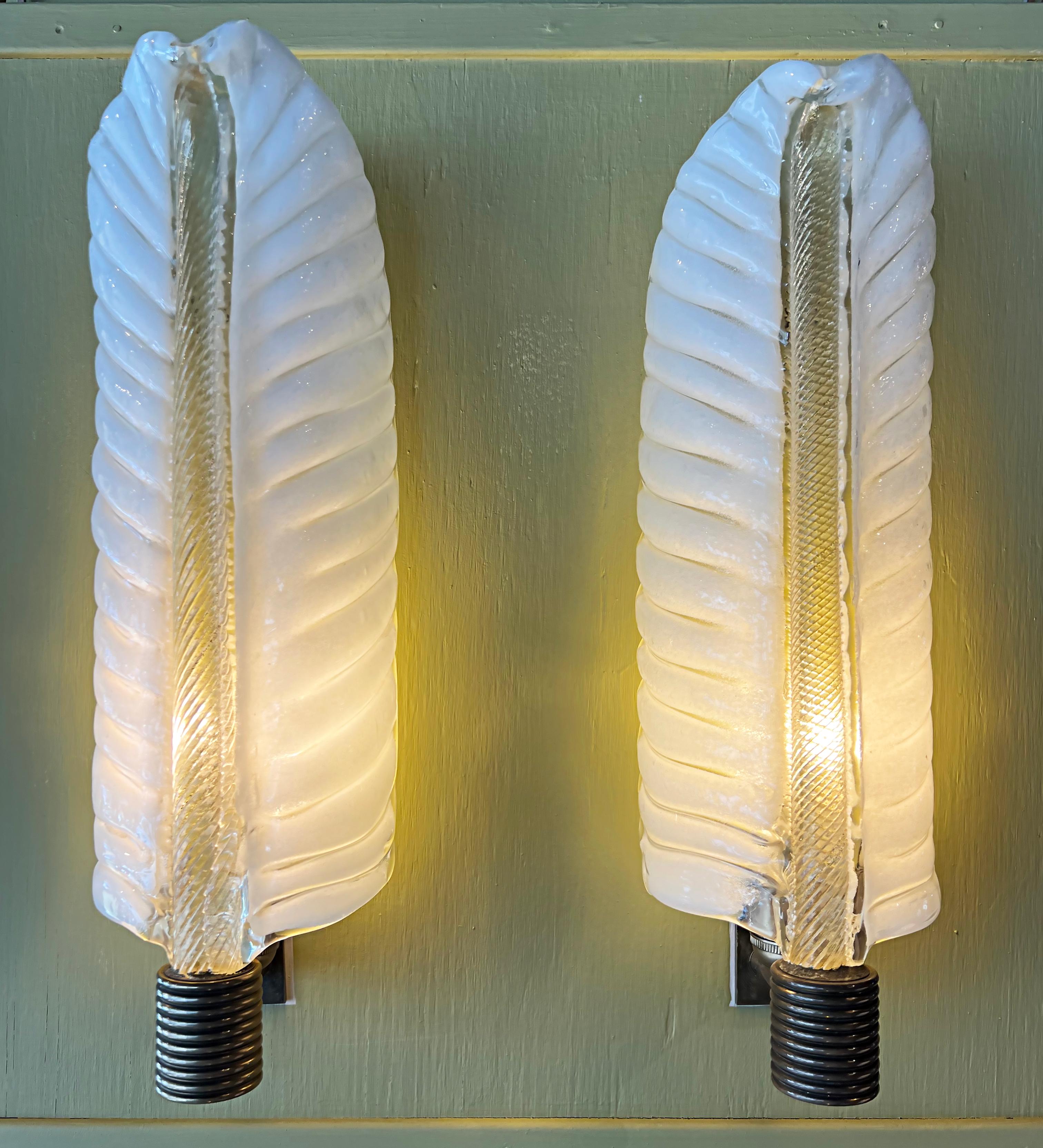 Barovier & Toso Murano blown glass wall sconces Acanthus leaf pair

Offered for sale is a pair of Italian 1940s Art Deco blown glass sconces from Barovier and Toso. These white and clear stylized acanthus leaf glass sconces have gold-infused stems