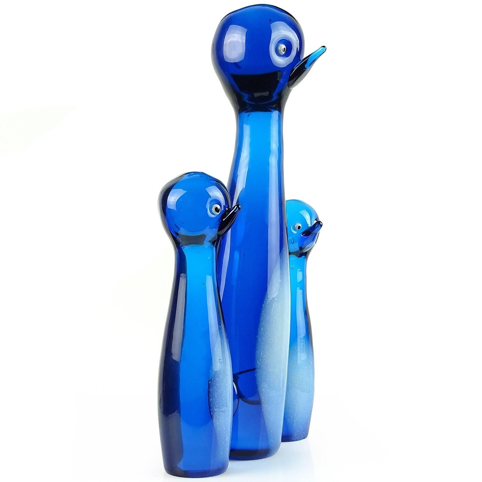 Beautiful large vintage Murano hand blown cobalt blue with opal snow white bellies Italian art glass penguin family sculpture. Documented to the Barovier e Toso Company. The smaller birds are attached at the sides of the larger mom penguin. Each has