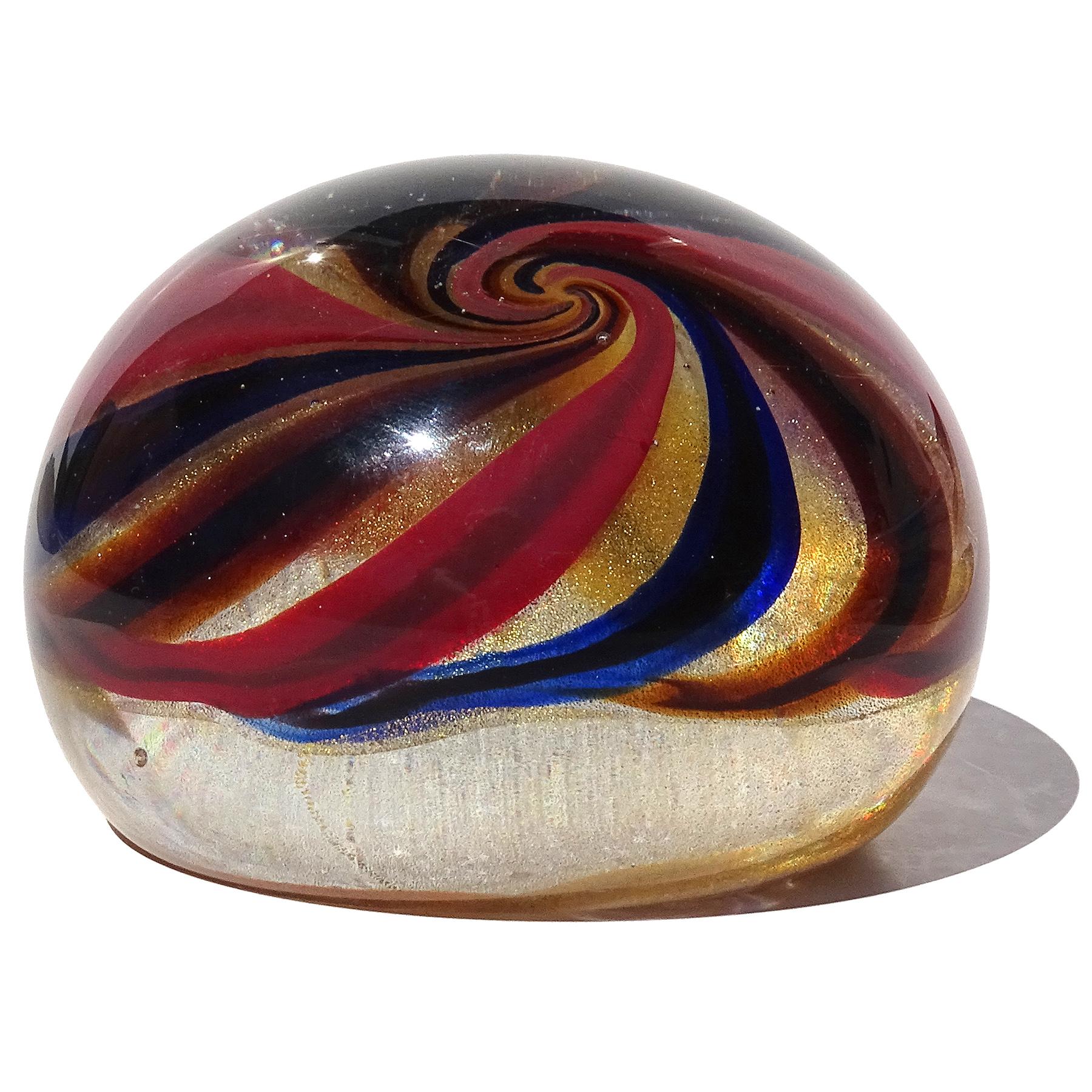 Beautiful and unusual, vintage Murano hand blown Sommerso multi color canes and gold flecks Italian art glass paperweight. Documented to designer to the Barovier e Toso company. Created with an optic swirling design of cut canes over a bed of