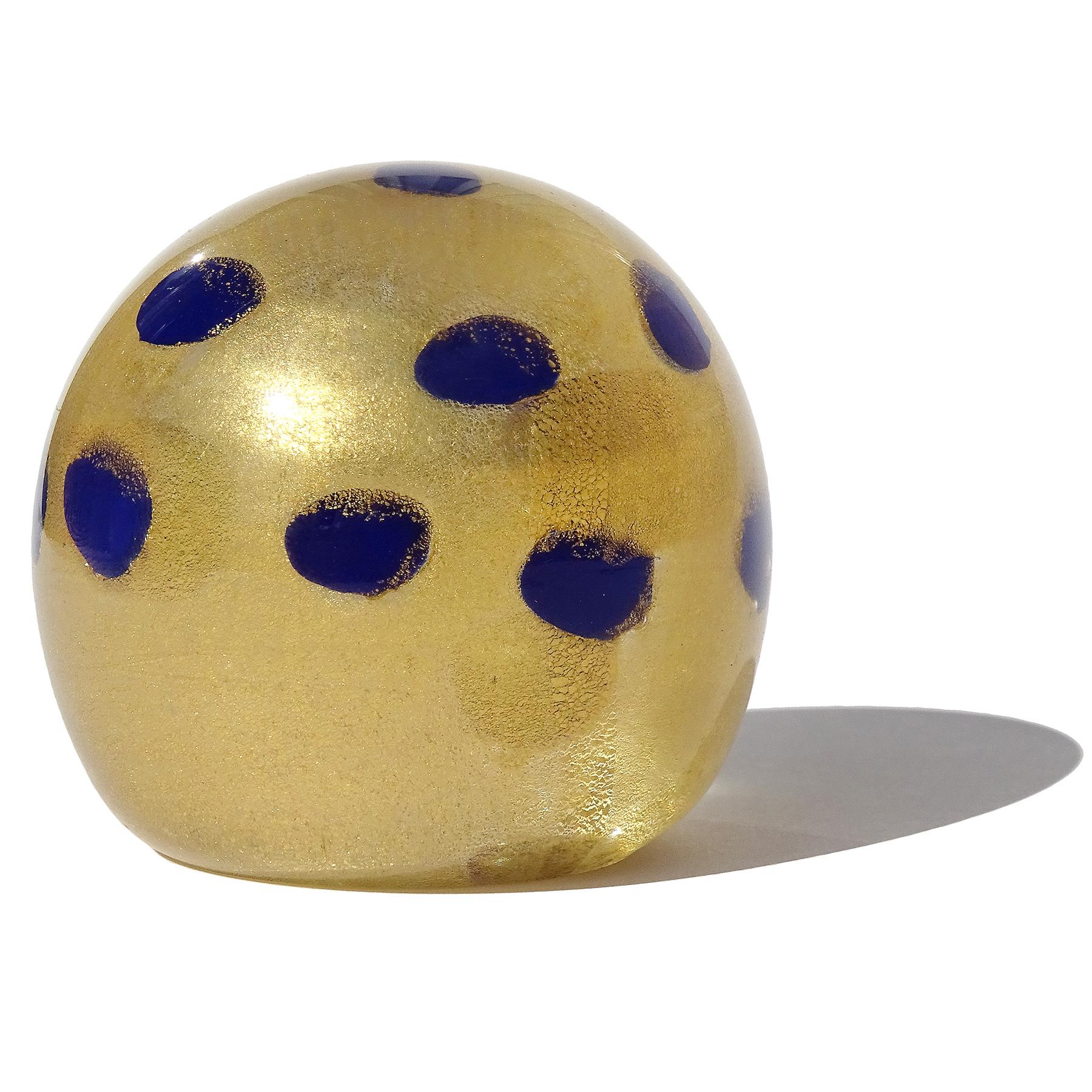 Beautiful small vintage Murano hand blown dark cobalt blue and gold flecks Italian art glass paperweight. Documented to the Barovier e Toso company. The piece is profusely covered in heavy yellow gold leaf throughout, with spots decoration. Would