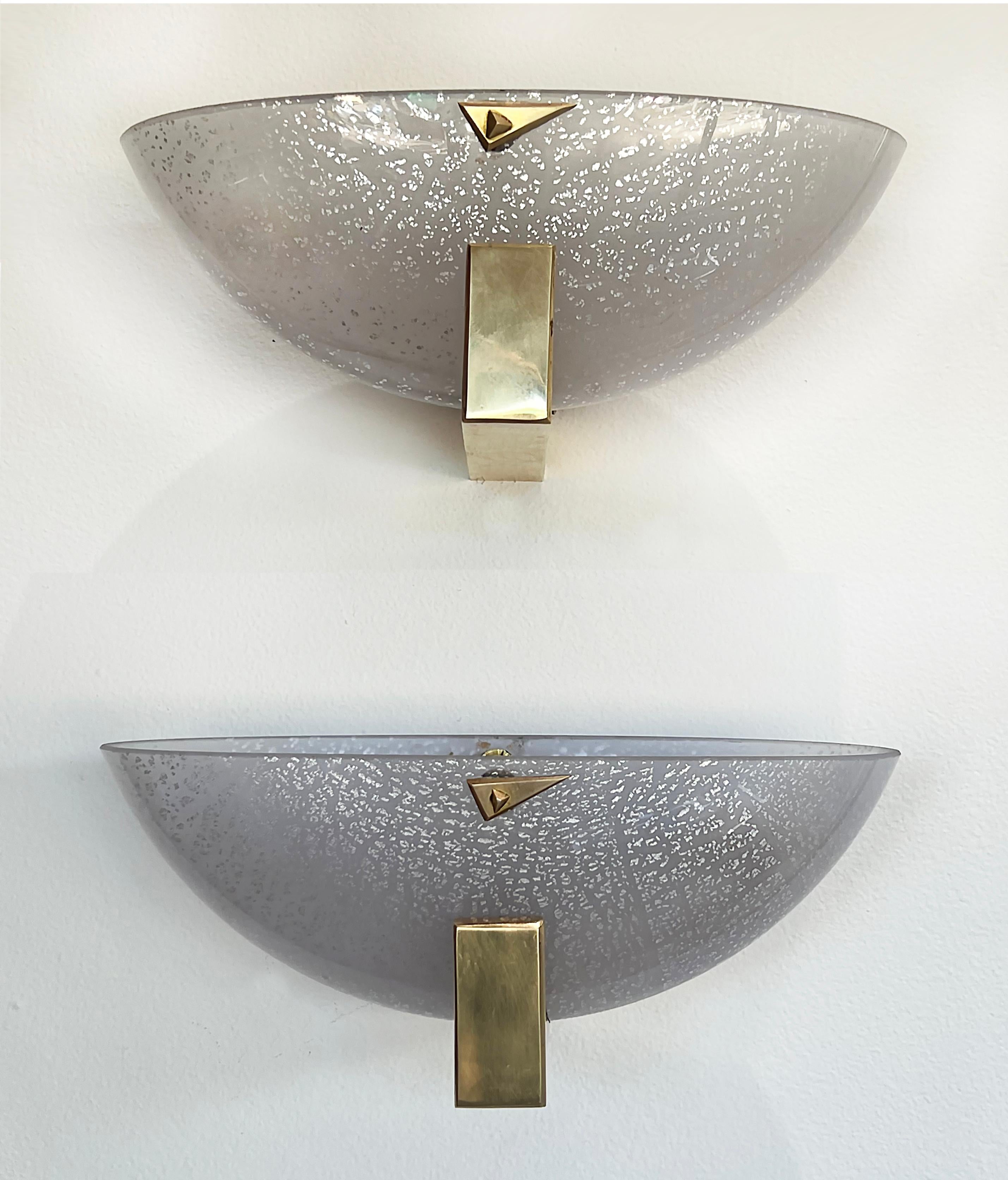 Barovier & Toso Murano glass Demilune sconces with Brass Details

Offered for sale is an elegant pair of Mid-century Modern Barovier & Toso sconces. The sconces have polished brass frames and accent detail and are fitted with Italian Murano glass