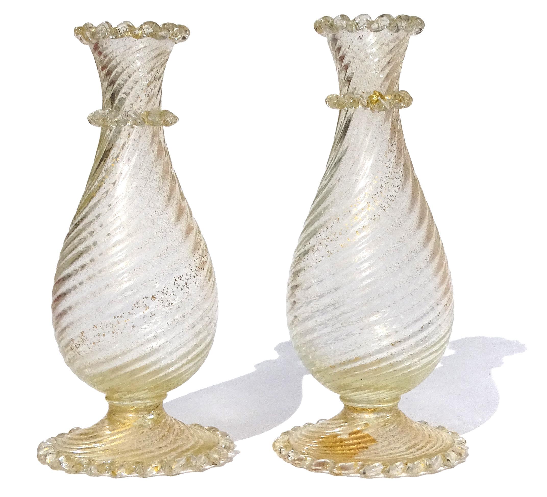 Beautiful pair of early Murano hand blown gold flecks Italian art glass footed flower vases. They are documented to the Barovier e Toso company. One has an almost complete 