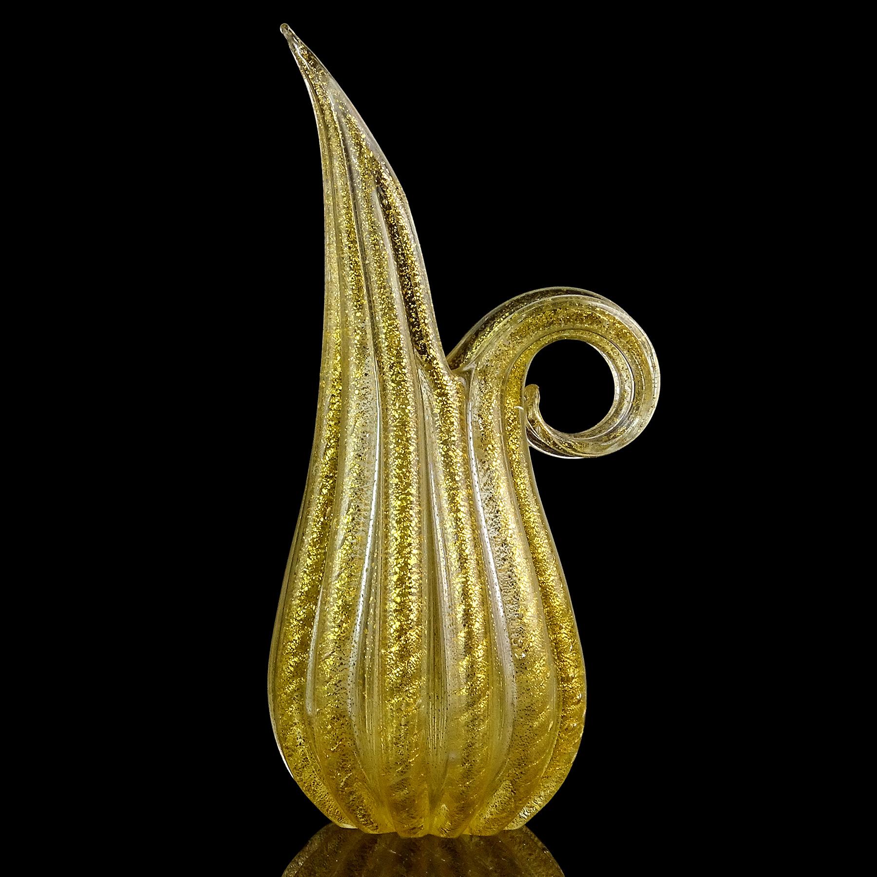 Beautiful vintage Murano hand blown gold flecks Italian art glass ribbed surface pitcher / vase. Documented to designer Ercole Barovier, for the Barovier e Toso Company. The piece has a ribbed design with ropes of gold, 