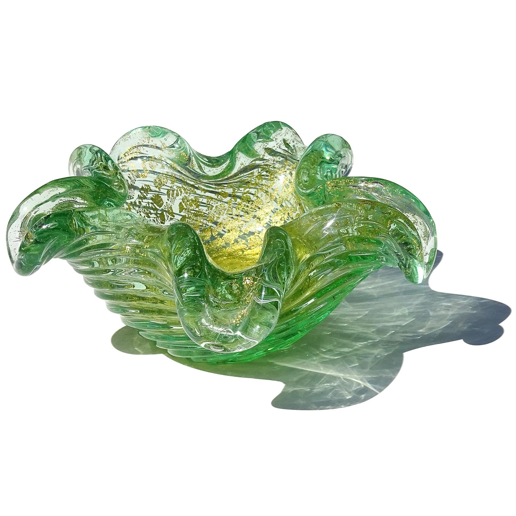 Beautiful vintage Murano hand blown green, controlled bubbles and gold flecks Italian art glass star / flower shaped bowl. Documented to the Barovier e Toso company. The piece is profusely covered with gold leaf on the inside, with a ribbed surface