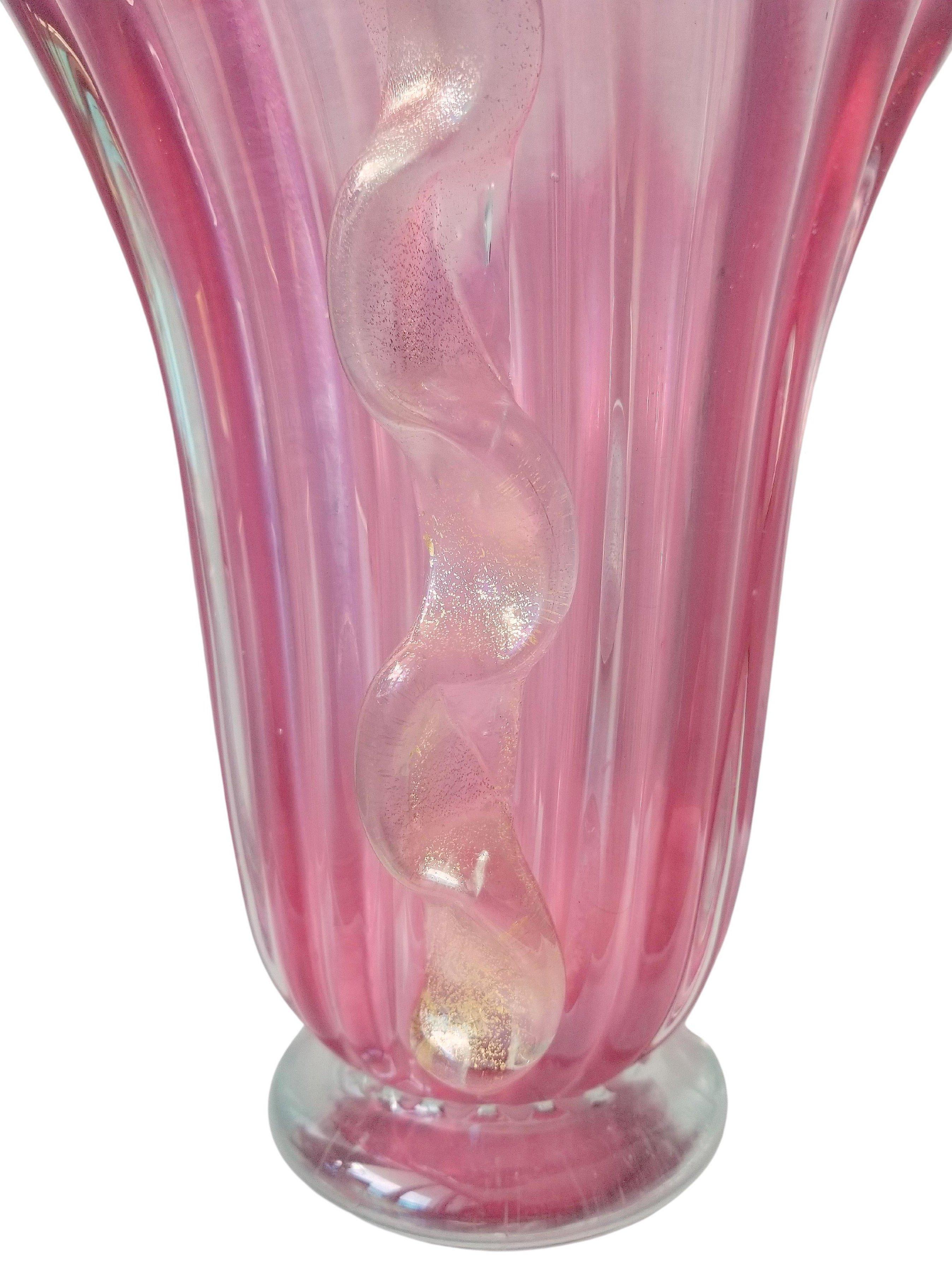 Large transparent pink handmade Murano glass vase. The vintage vessel is enriched by side applications of shaped glass with a characteristic Morise wavy pattern with gold aventurine. The ribbed campana shaped body has an iridescent finish on the