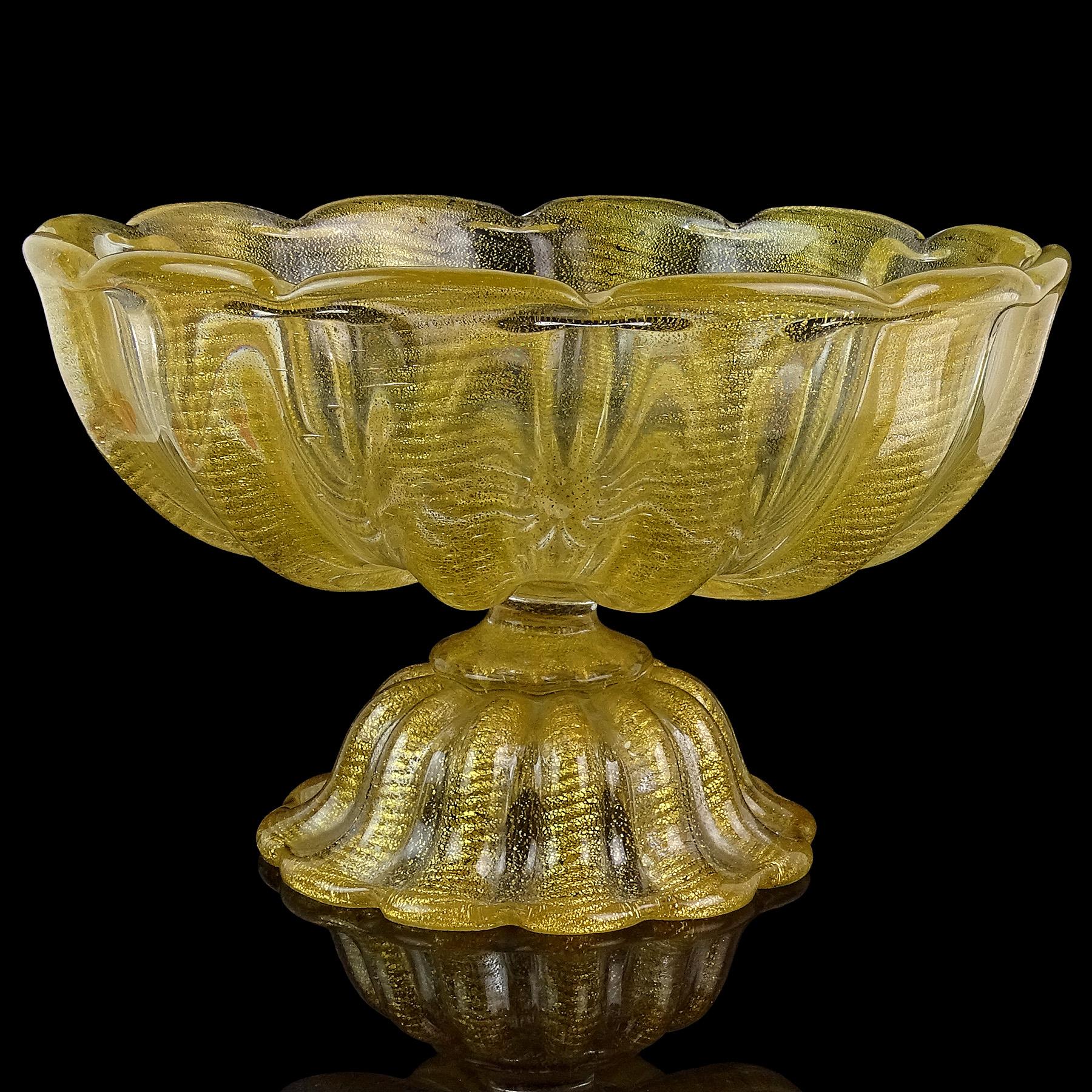 Beautiful, and very large, vintage Murano hand blown gold flecks Italian art glass footed compote bowl. Documented to designer Ercole Barovier for Barovier e Toso, circa 1950s. The bowl has a ribbed design, and scalloped rim, with ropes of gold