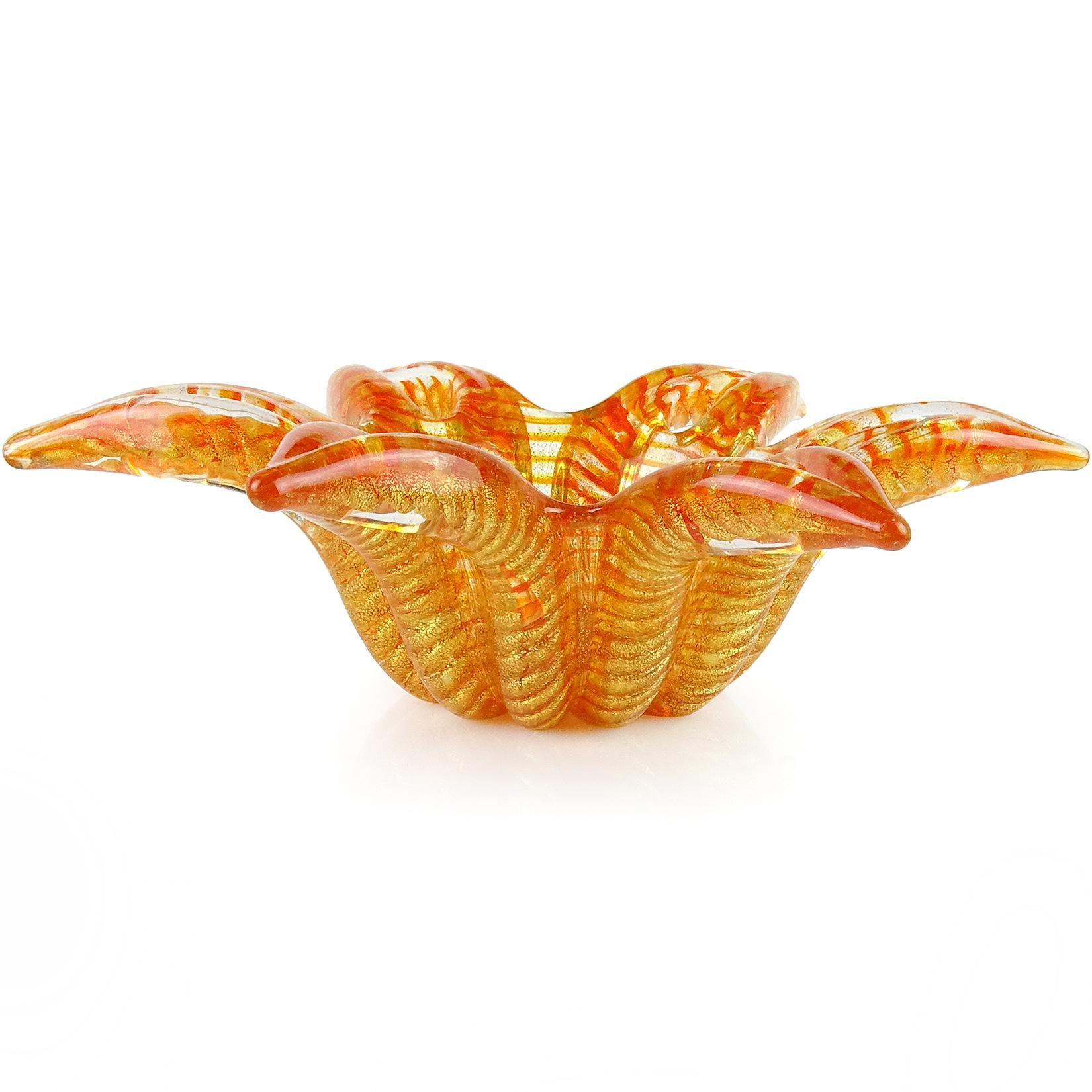 Beautiful vintage Murano hand blown orange and gold flecks Italian art glass star / flower shaped bowl. Documented to designer Ercole Barovier for Barovier e Toso. The piece is profusely covered with gold leaf on the outside, in the 