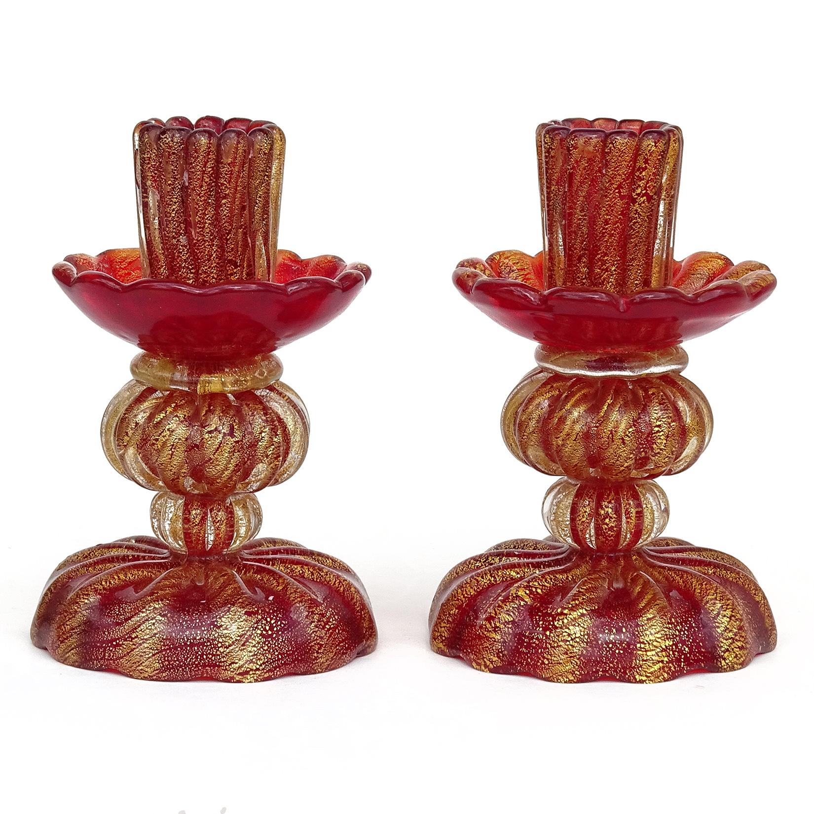 Beautiful vintage Murano hand blown deep red and gold flecks Italian art glass matching pair of candlesticks. Documented to designer Ercole Barovier, for Barovier e Toso. Both candle holders have the original 