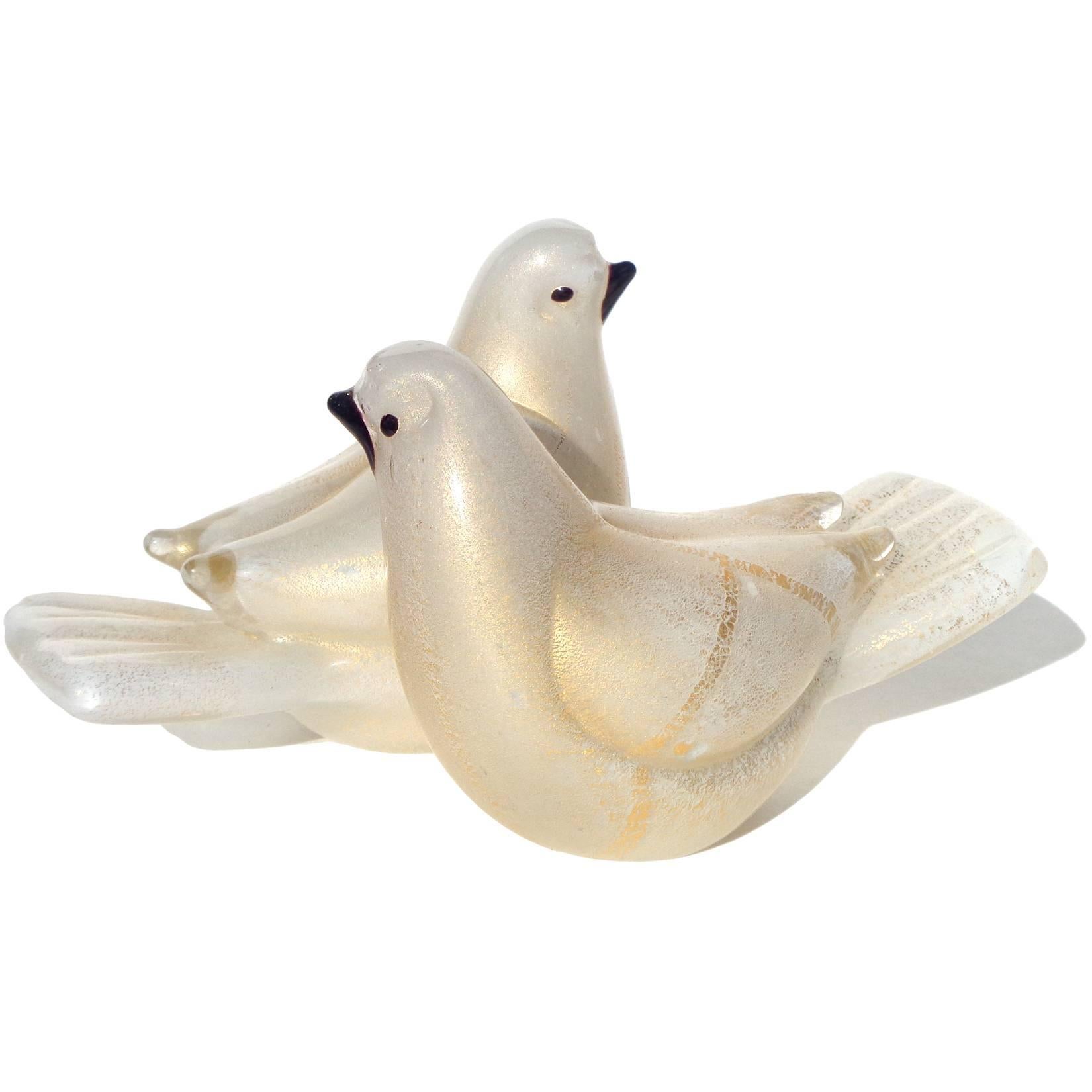 Beautiful Murano hand blown white and gold flecks art glass love birds sculpture. Documented to the Barovier e Toso company. The two birds are attached at the sides, and are profusely covered in gold leaf. Measures 6