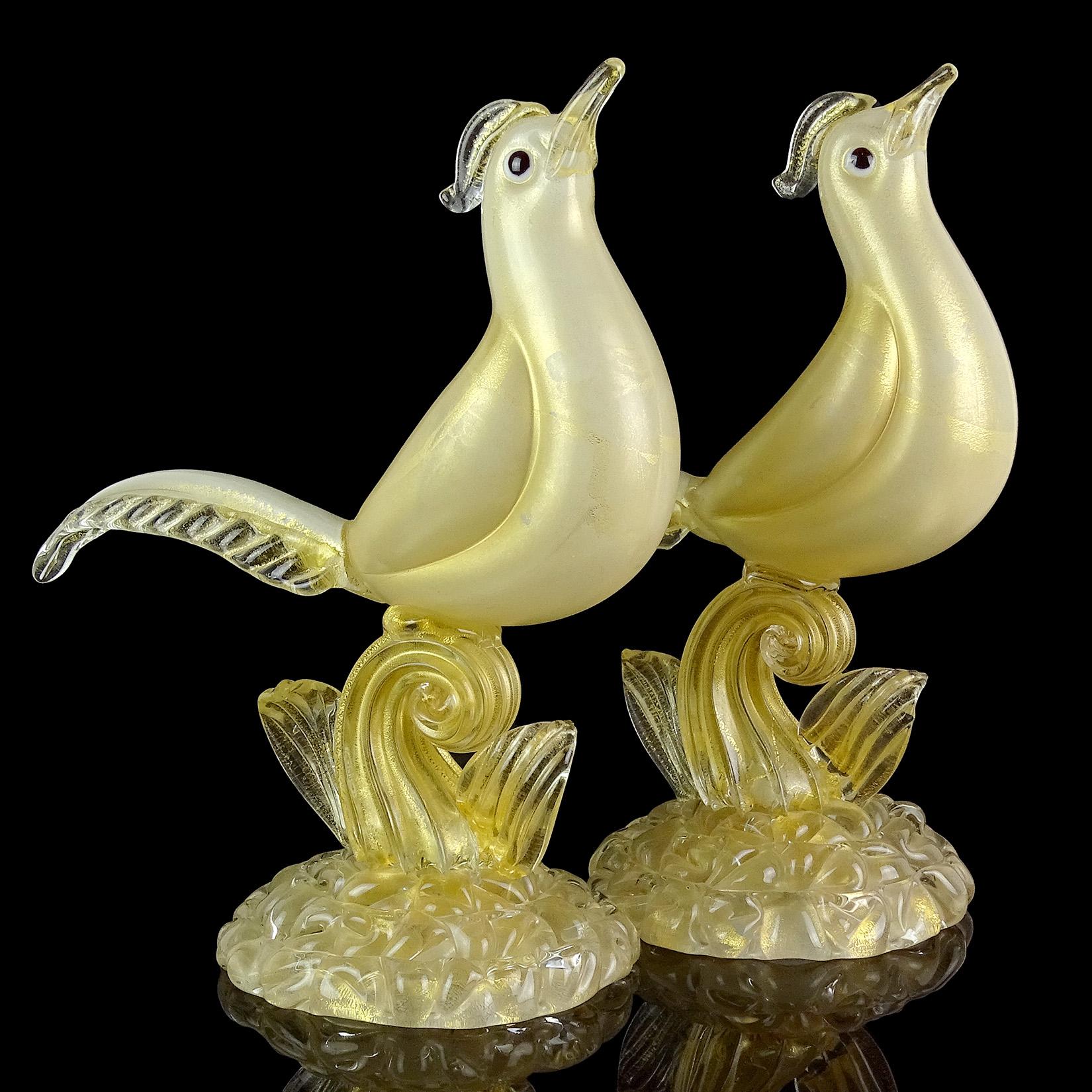Priced per item (2 birds available as shown). 
Gorgeous and rare, vintage Murano hand blown white and gold flecks Italian art glass pheasant bird sculpture on base. Documented to designer Ercole Barovier, for the Barovier e Toso company. The base is