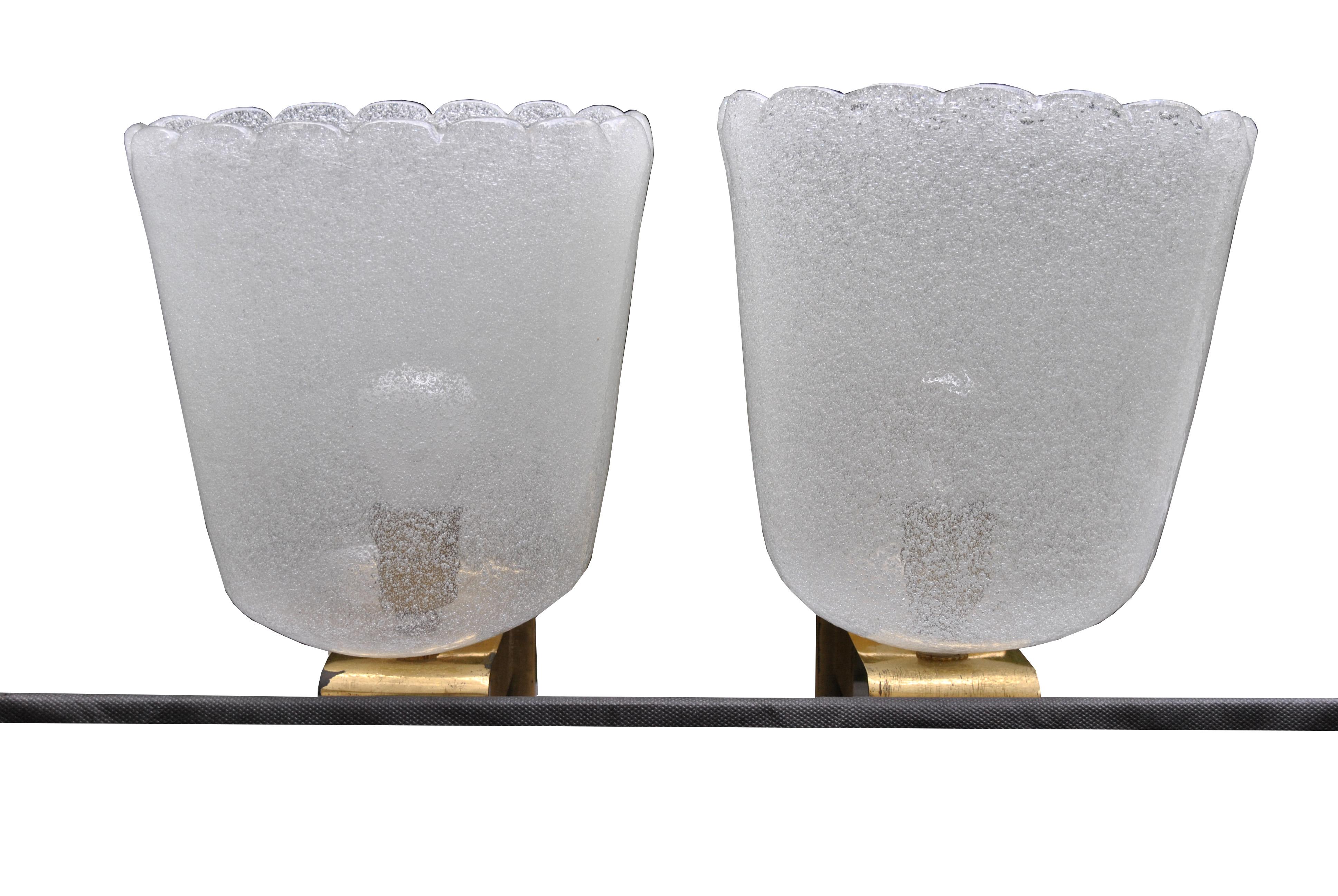 Pair of wall sconces in Murano glass and brass base by Barovier & Toso.
Barovier & Toso has existed since the mid-13th century and is therefore the sixth oldest family businesses in the world still in business as well as masters in glass processing.