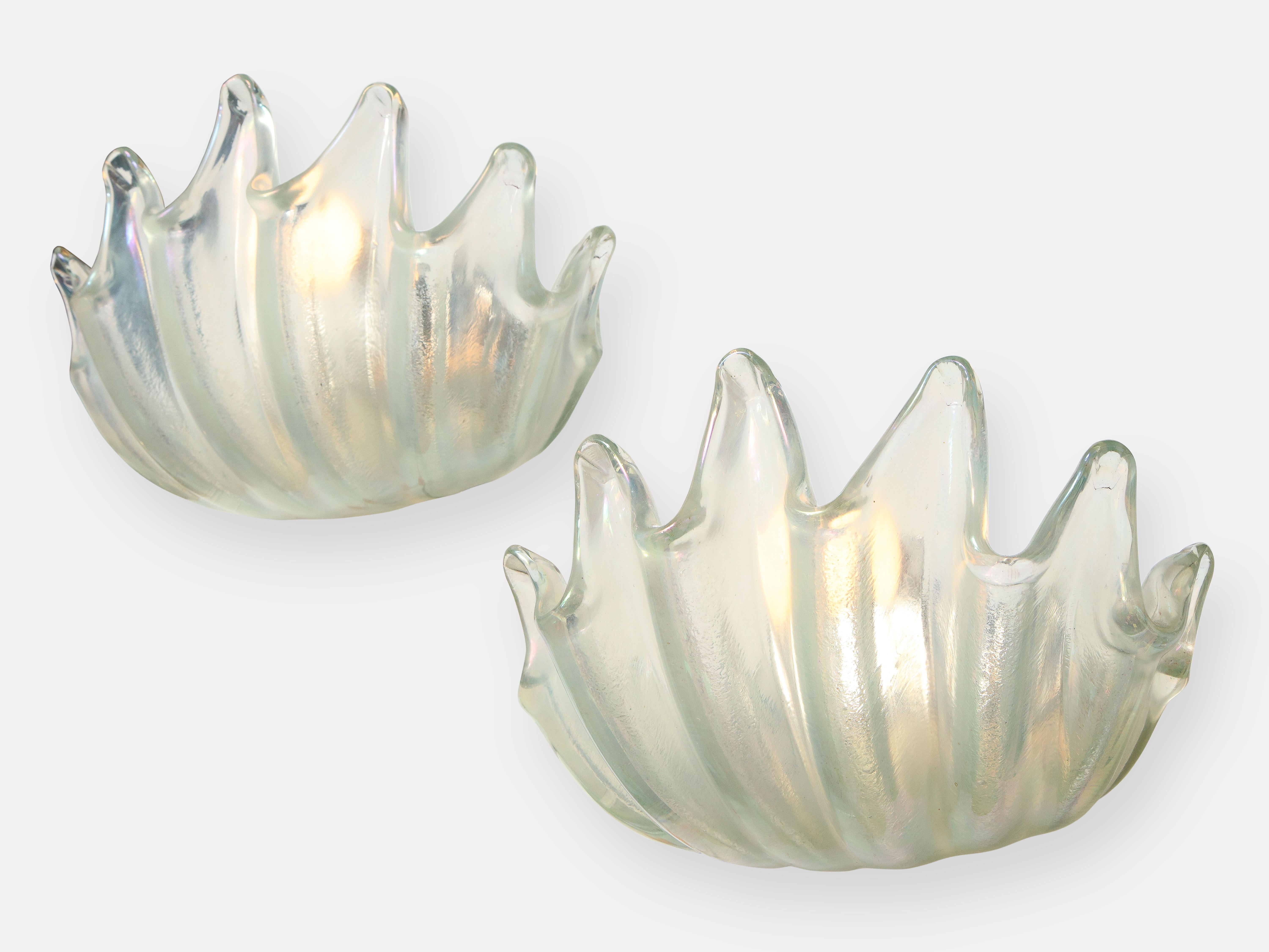 Ercole Barovier for Barovier & Toso extremely rare set of four large clamshell sconces in heavy transparent iridescent glass featuring deep ribbing and pronounced lobes, Italy, circa 1940. These exquisite crystal wall lights are elegant and