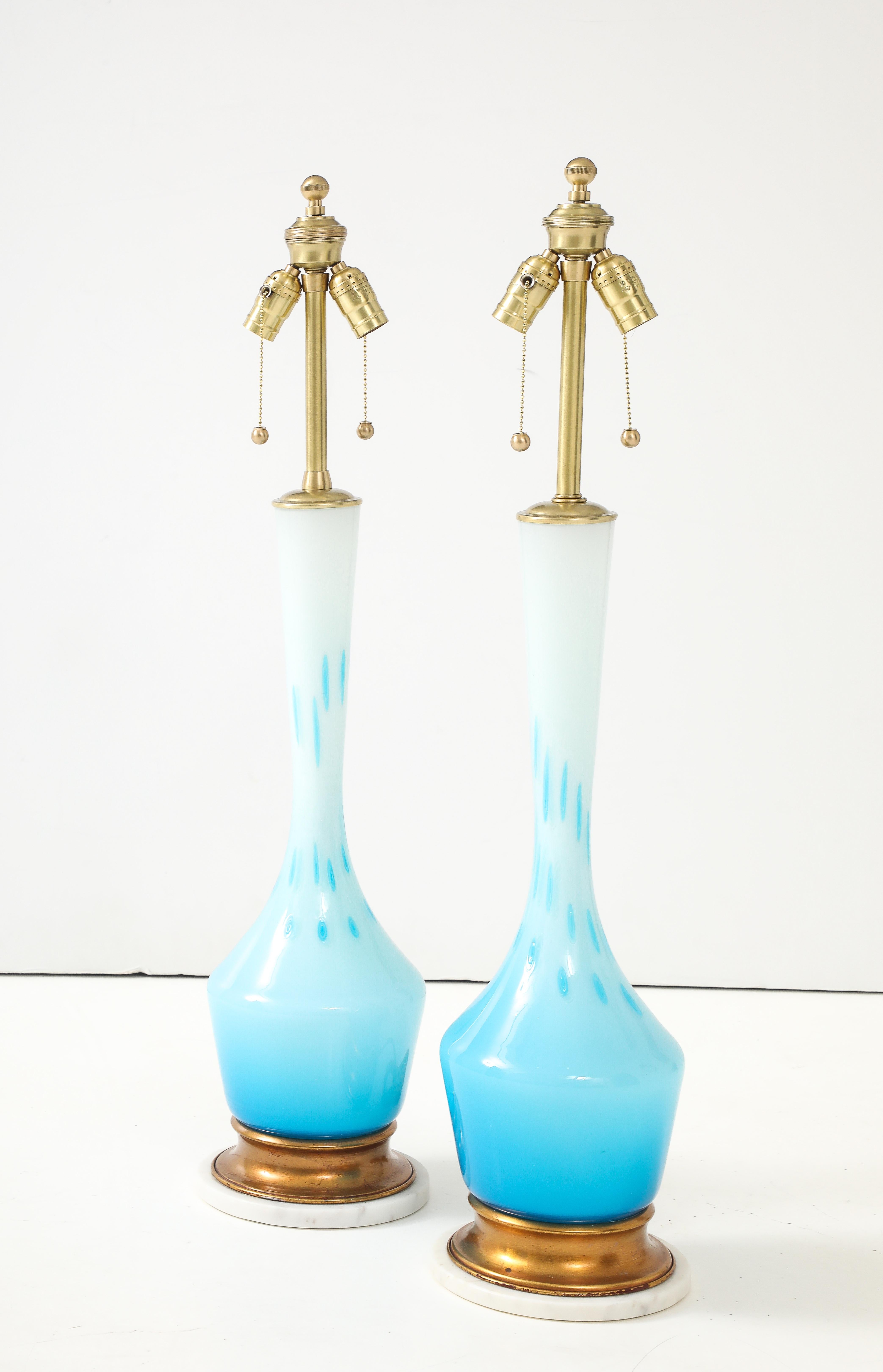 Pair of Mid Century Murano glass lamps in Robin's Egg / Tiffany Blue with a White ombre effect. Lamp bodies rest on gilded base which is then on a white marble disc.  Rewired by a professional electrician, 75W max, higher if LED bulbs are used.