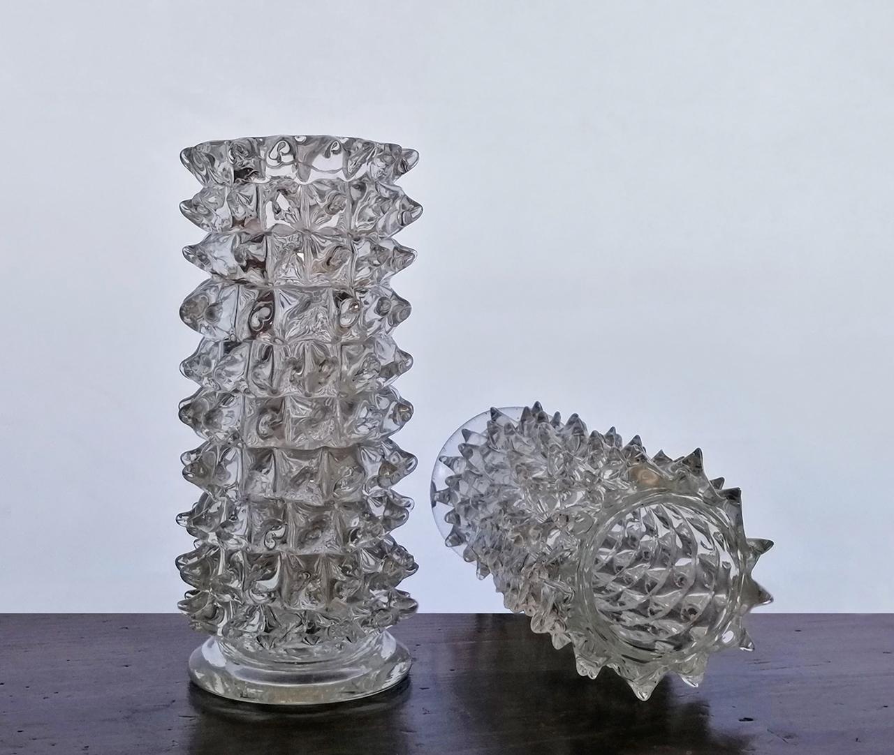 Two cylindrical glass vases produced by the famous Barovier manufacture of Murano in the 1940s.
This type of vase is called “rostrato” due to its beak-shaped spikes.
The vases are in good condition with a few minor chips on thespikes, two or three