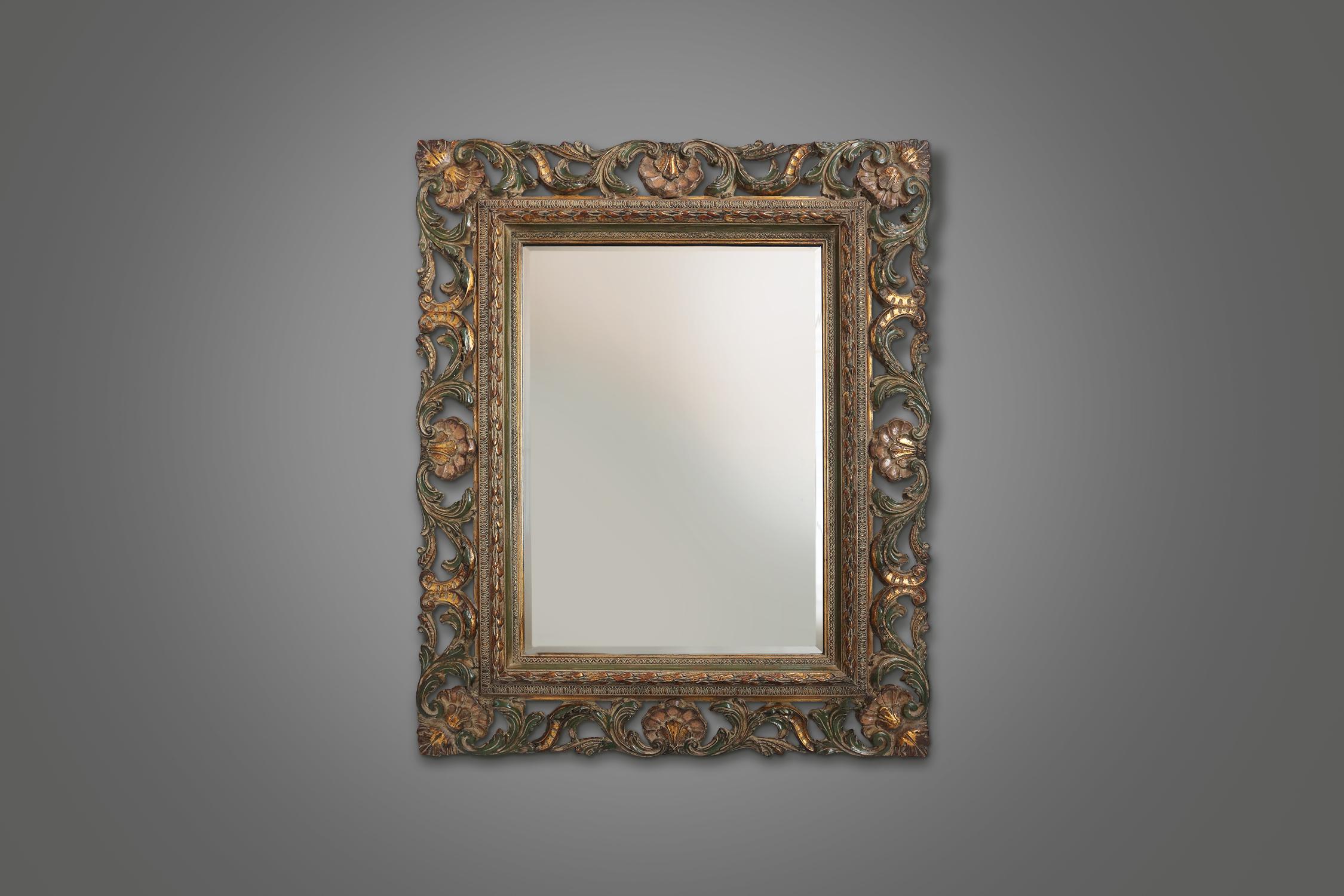 This mirror is more than an ordinary mirror. It is a masterpiece of craftsmanship and elegance. The mirror has a rectangular shape with an opulent, made in resin. The frame is decorated with intricate designs and patterns that reflect the style and