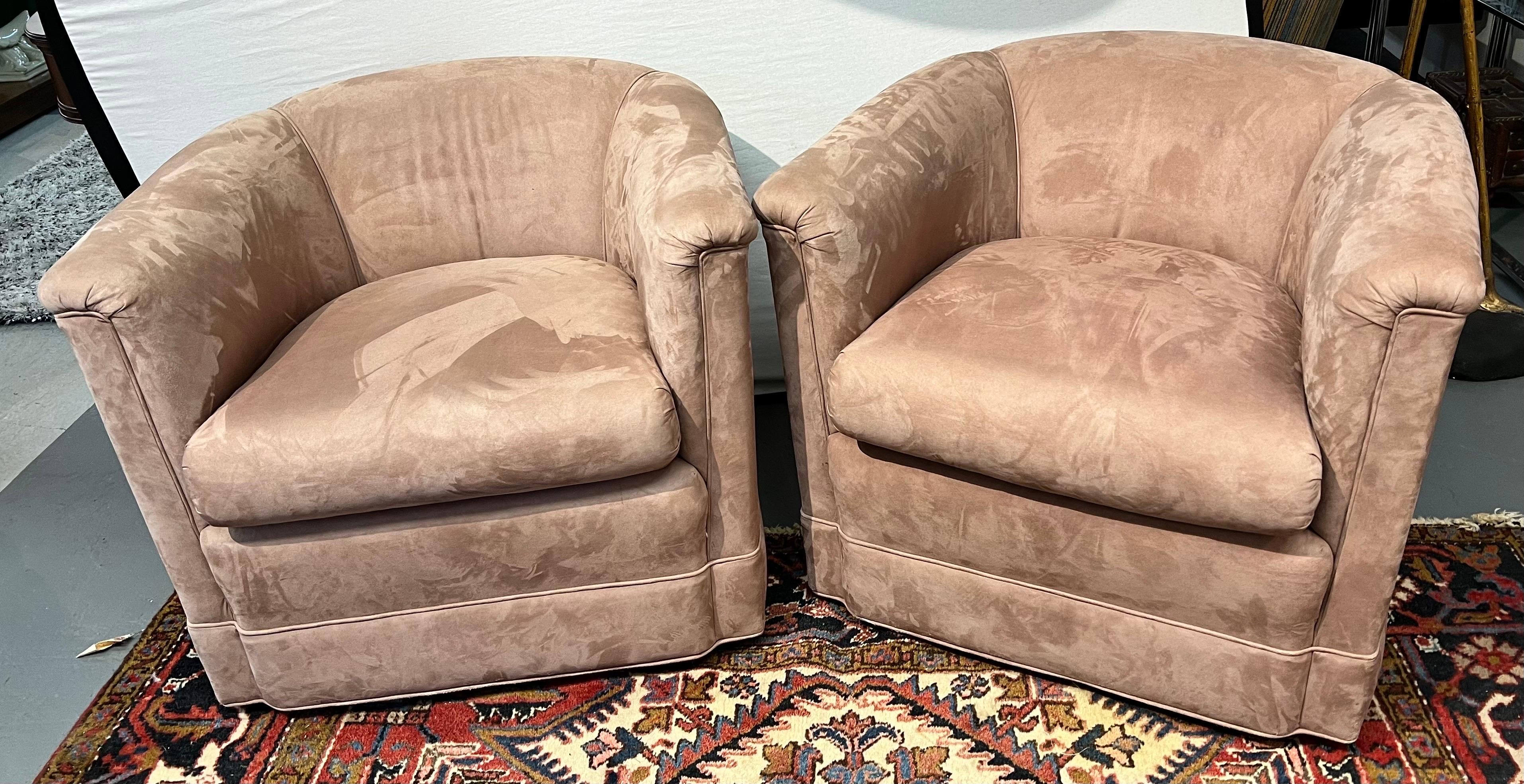 Sleek pair of newly upholstered barrel chairs from the 1970's.
The new fabric is a blush colored micro suede which is neutral
and will compliment many design aesthetics. They sit beautifully and are
ready for their new home. Why not own the best?