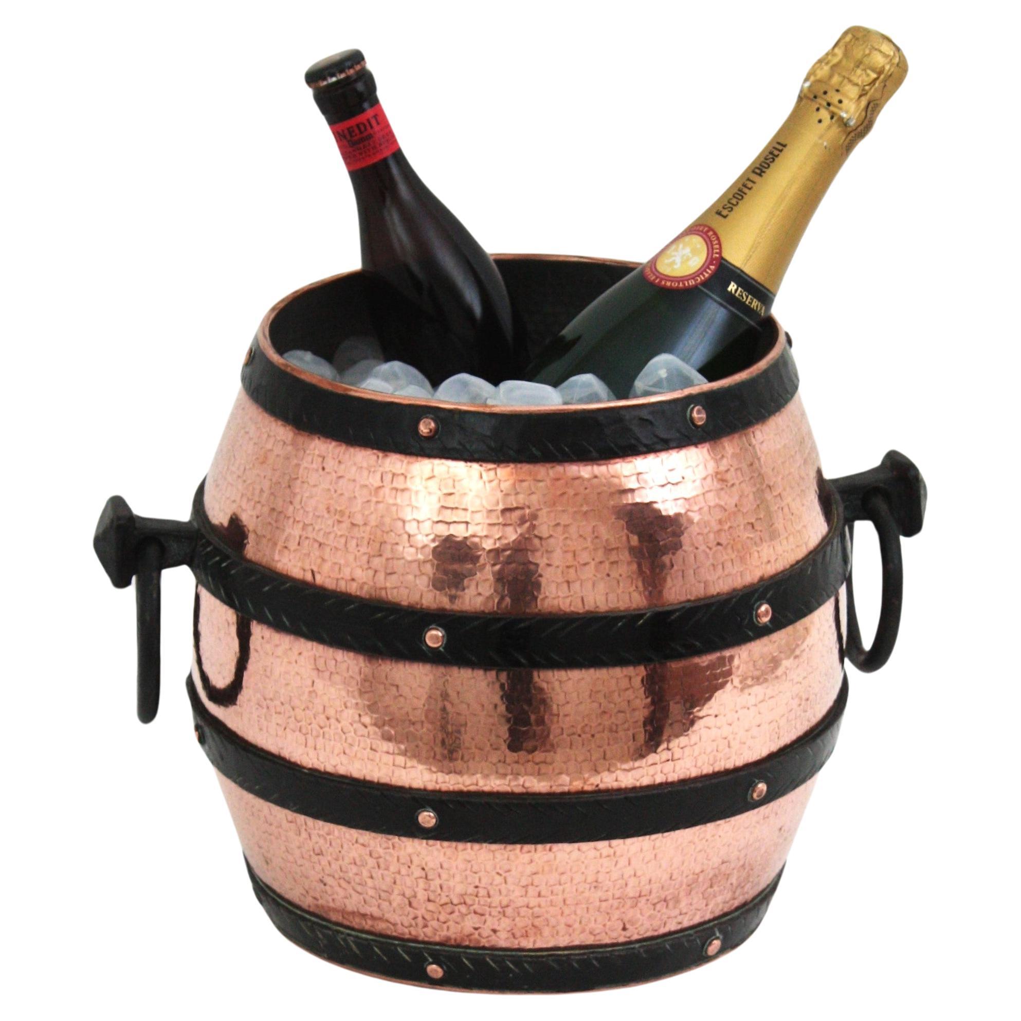 Hand forged copper and iron barrel shaped wine cooler, Spain, 1940s
 Eyecatching barrel copper ice bucket with iron braces and ring handles at both sides. The copper ice container is richly adorned by the hammer marks. It allows to place inside two