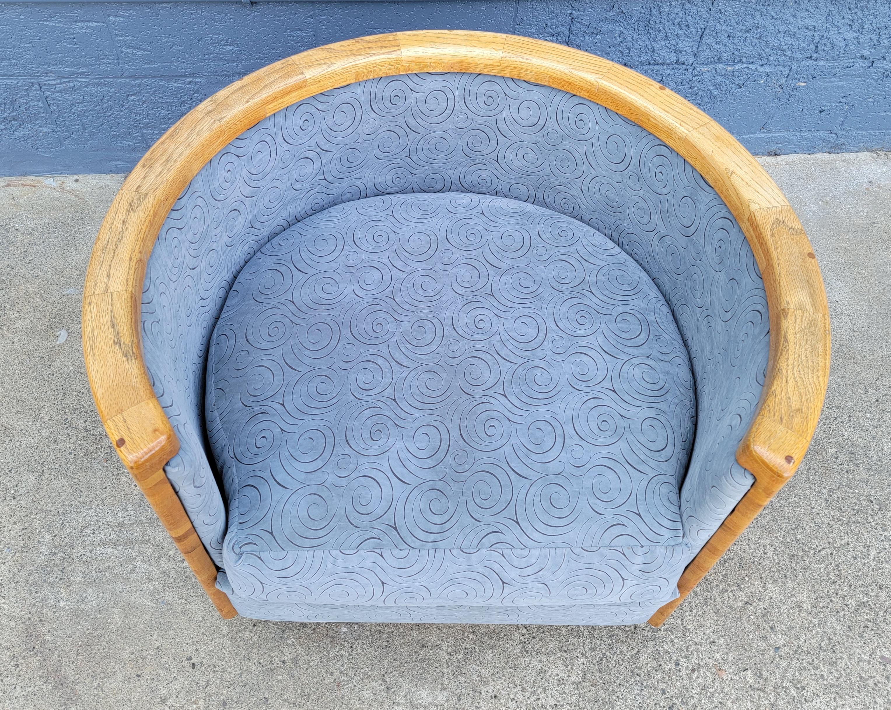 Substantial swivel lounge chair made of solid butcher block. Perfect circular form with opening for seating. Very recent new upholstery. Reversible seat cushion. This is a finely crafted, solid wood, heavy chair.