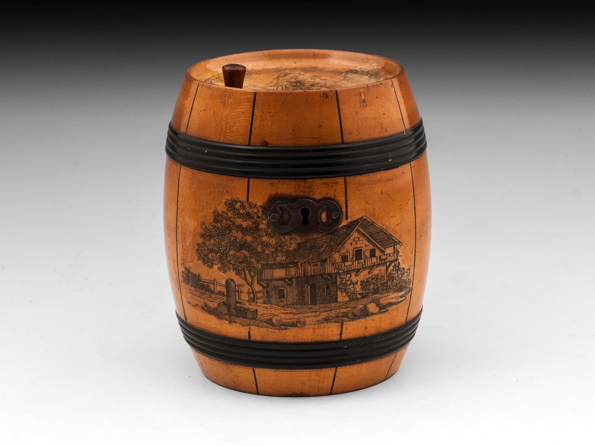 Unusual tea caddy in the shape of a barrel, with ebonised strapping and transferware prints. With a steel oval escutcheon, lock and hinge. 

The interior of the Barrel tea caddy contains trace of its original lining and has a fully working lock