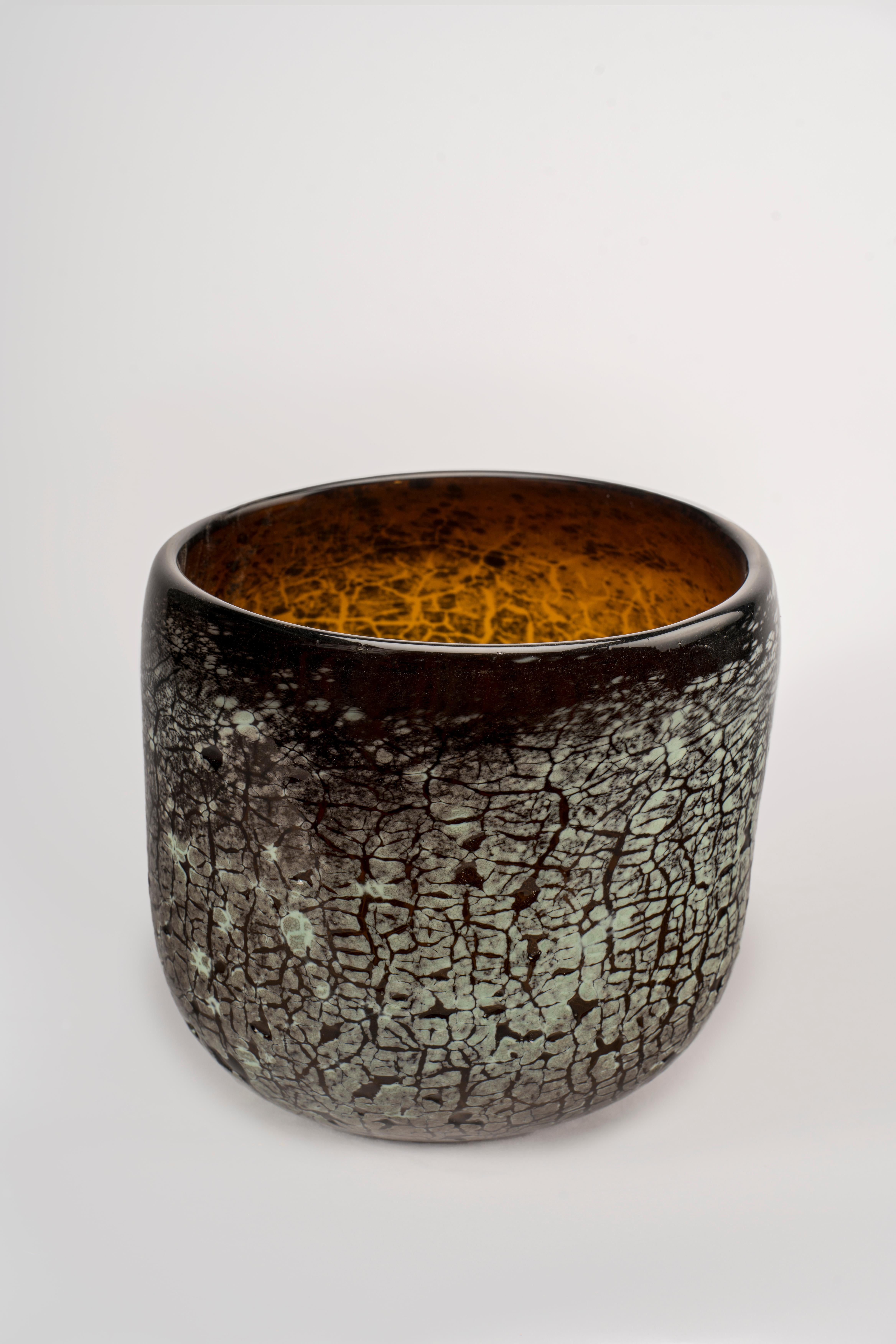 The Barren Bliss made by Glass artist Brent Sheehan, is a beautiful piece of art that captures the essence of an earthen look while still maintaining its delicate and intricate glass construction. The vase has a unique crackle effect, created by
